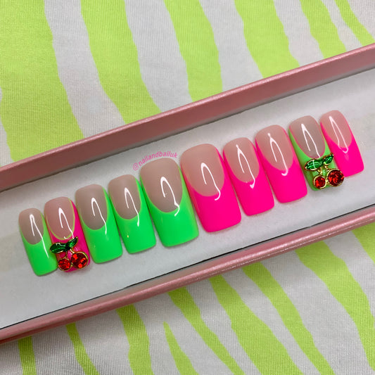 Introducing "Cherry Apple" Press-On Nails – a burst of vibrant style for your fingertips! 🍒🍏 With neon green and pink French tips and adorable cherry nail charms, these nails are the perfect blend of playful and eye-catching. Elevate your look effortlessly! Order "Cherry Apple" Press-On Nails now and make your nails pop with a touch of sweetness and charm! 💅