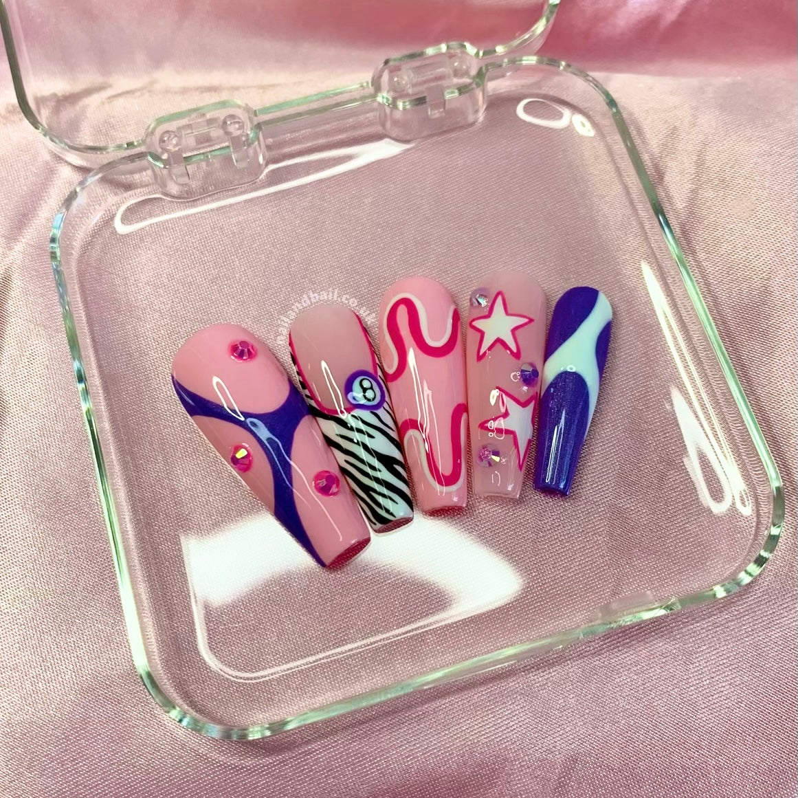 Y2K press-on nails with 8 ball nail art, zebra print, stars, and crystal details
