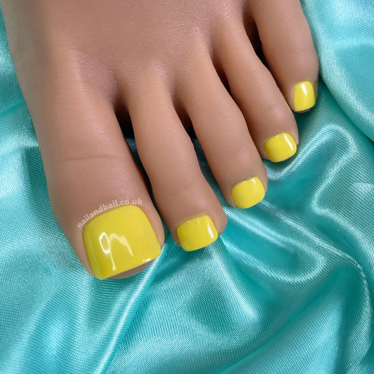 Meet Buttercup Shine press-on toe nails: vibrant yellow with a glossy finish for instant sunshine vibes. Easy to apply and perfect for any occasion, they're your go-to for bright, trendy toes this season!