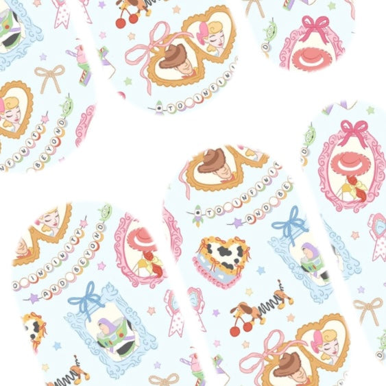 Close up of Bo’s Boutique handmade nail decals featuring bows, western-inspired Toy Story artwork and pastel details.