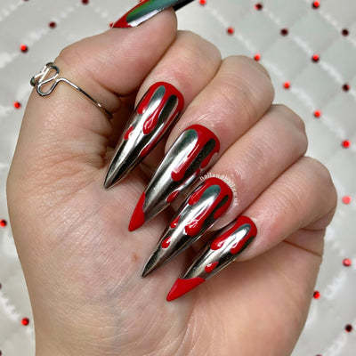 Silver chrome press-on nails with red blood drip nail art and horror-inspired details