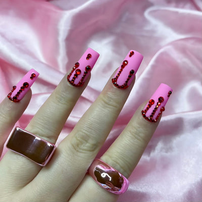 Matte pink press-on nails with red crystal blood drip nail art
