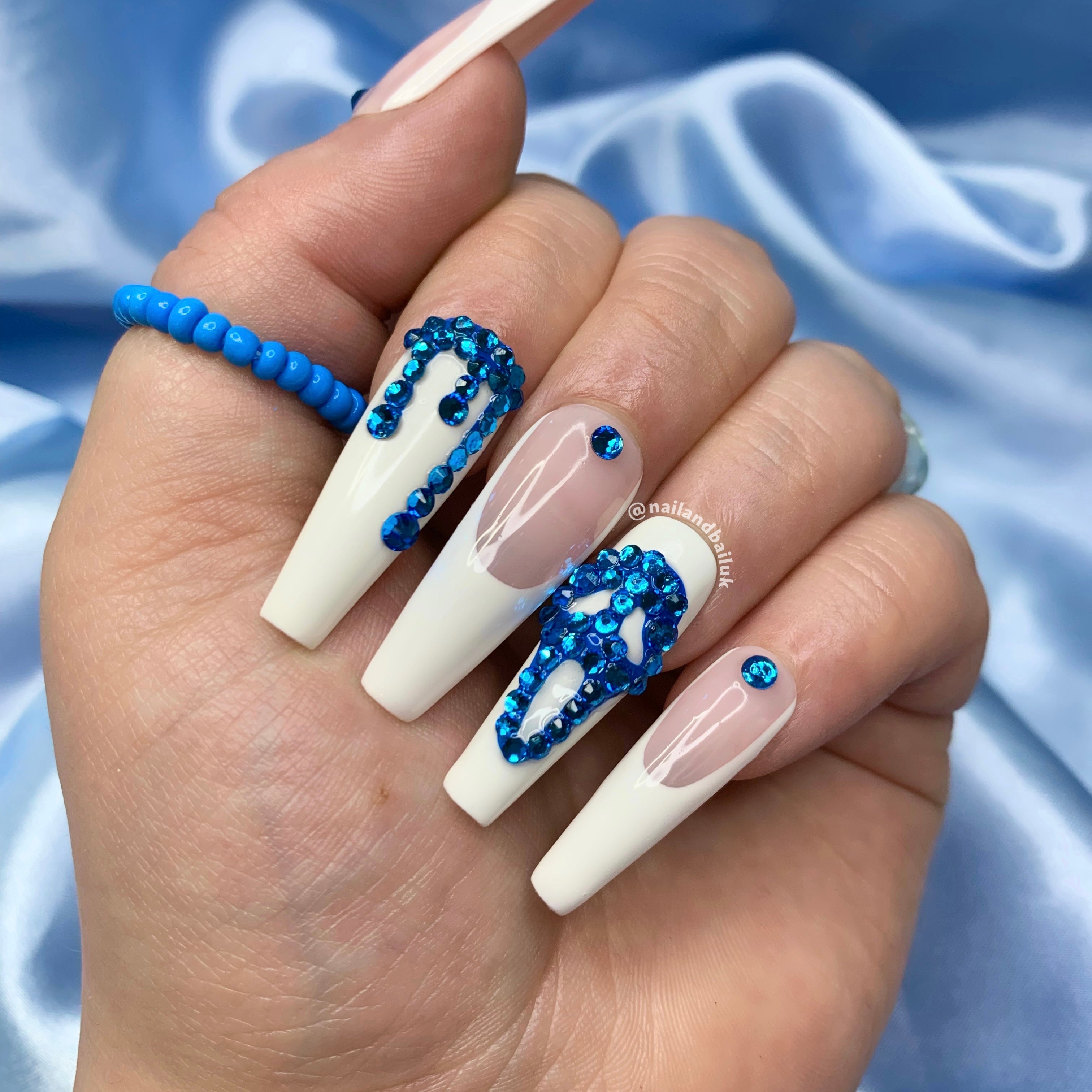 Sparkling crystal nail art on horror-inspired French tip press-on nails