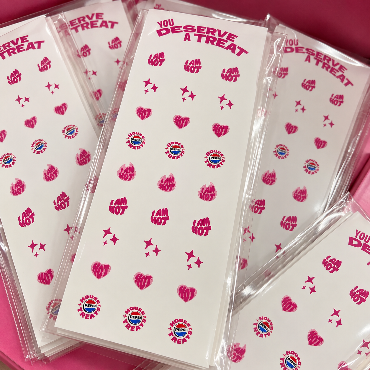 Close-up of custom Pepsi event nail decal sheets featuring I AM HOT, heart and House Treats designs