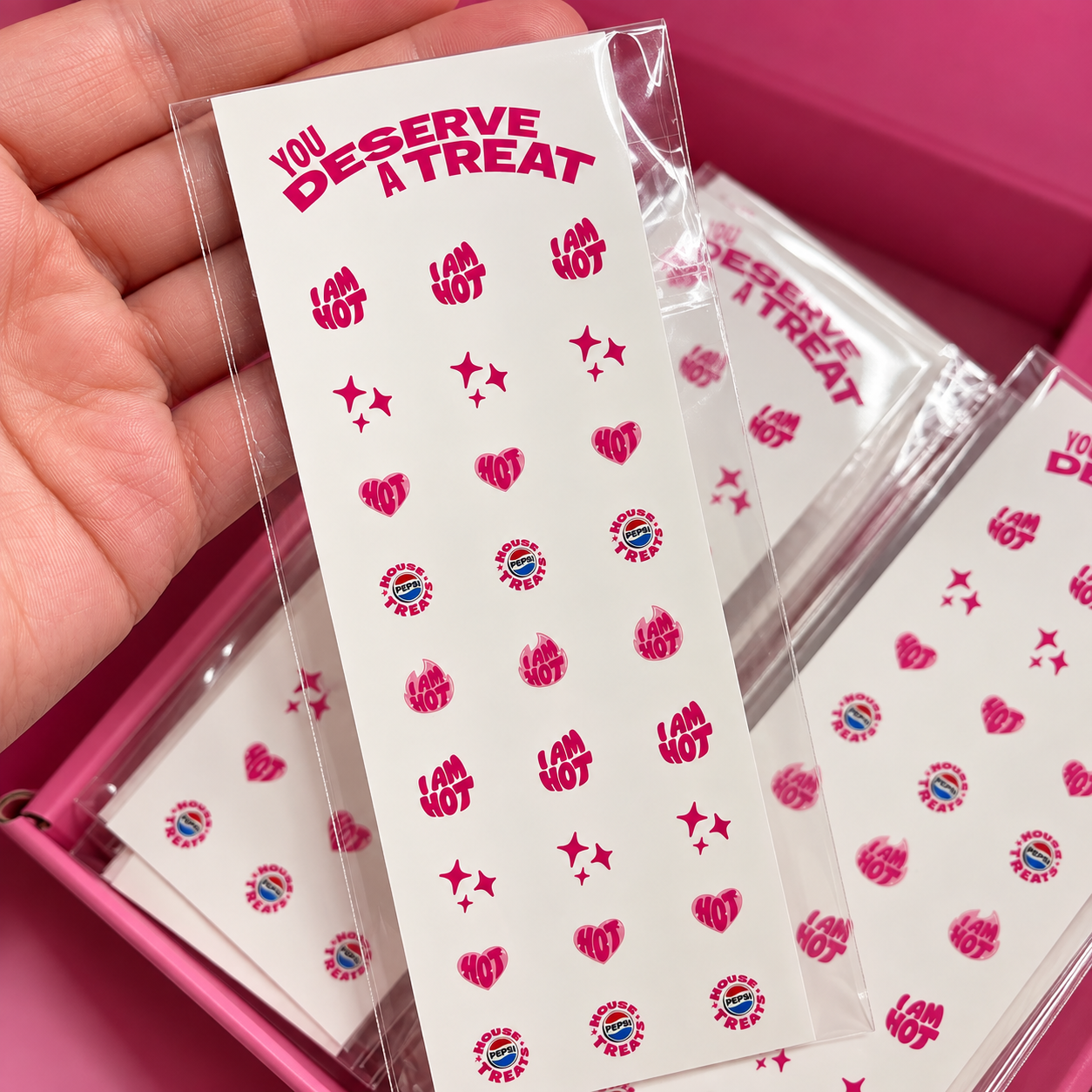 Custom Pepsi waterslide nail decal sheet held up to show the finished printed designs