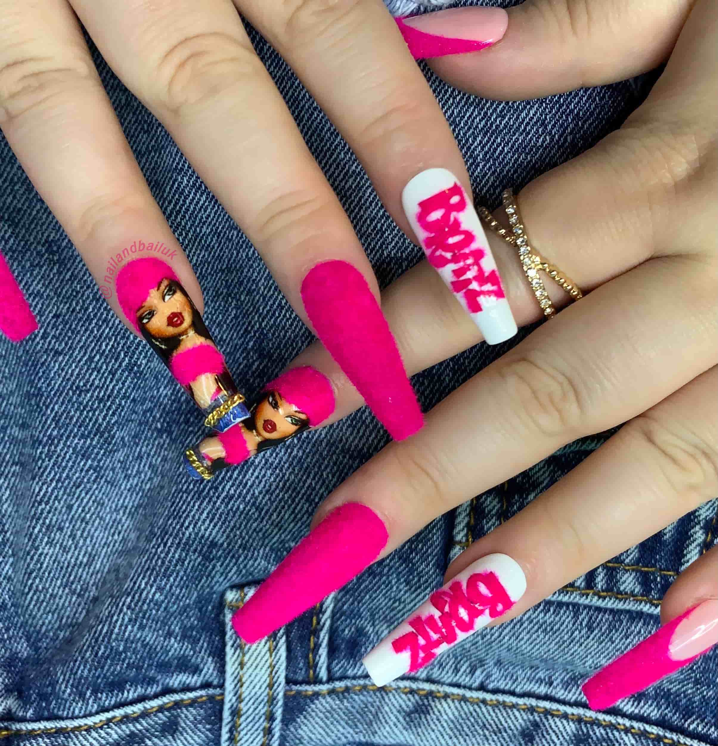 Nude press-on nails with bold fuchsia French tips and gold chain embellishments