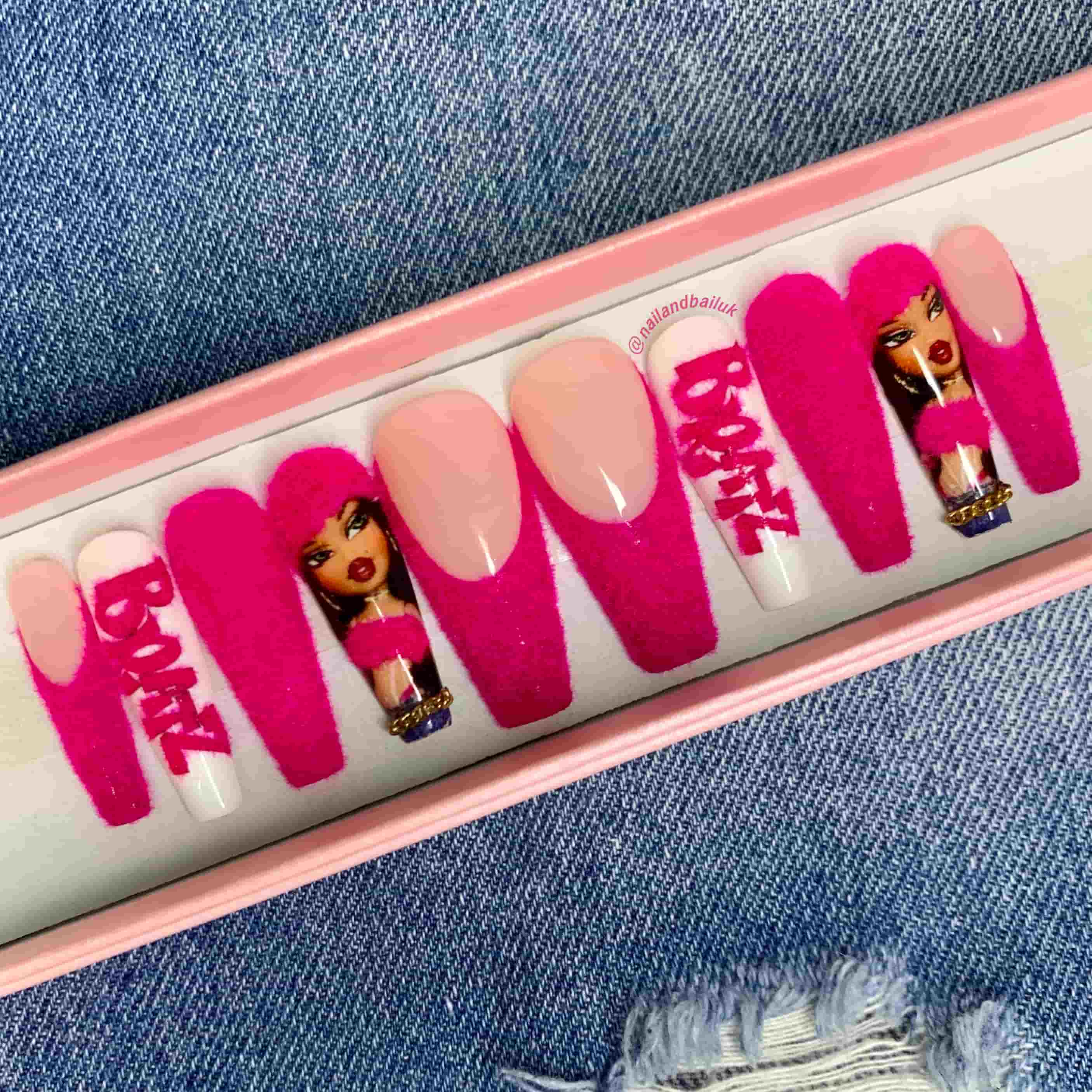 Bright pink French tip press-on nails with glamorous gold chain details