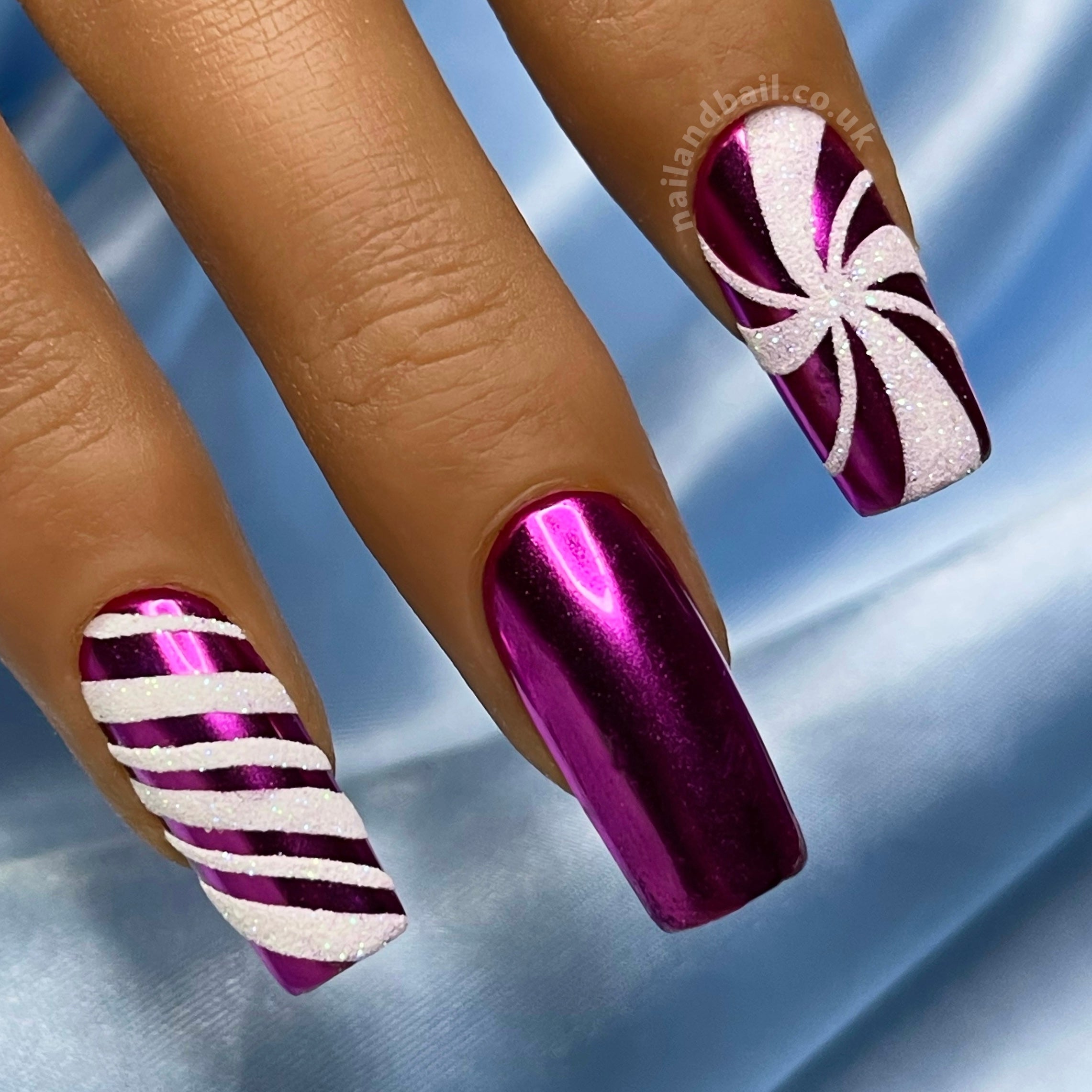 White glitter candy cane nail art on purple chrome Christmas press-on nails