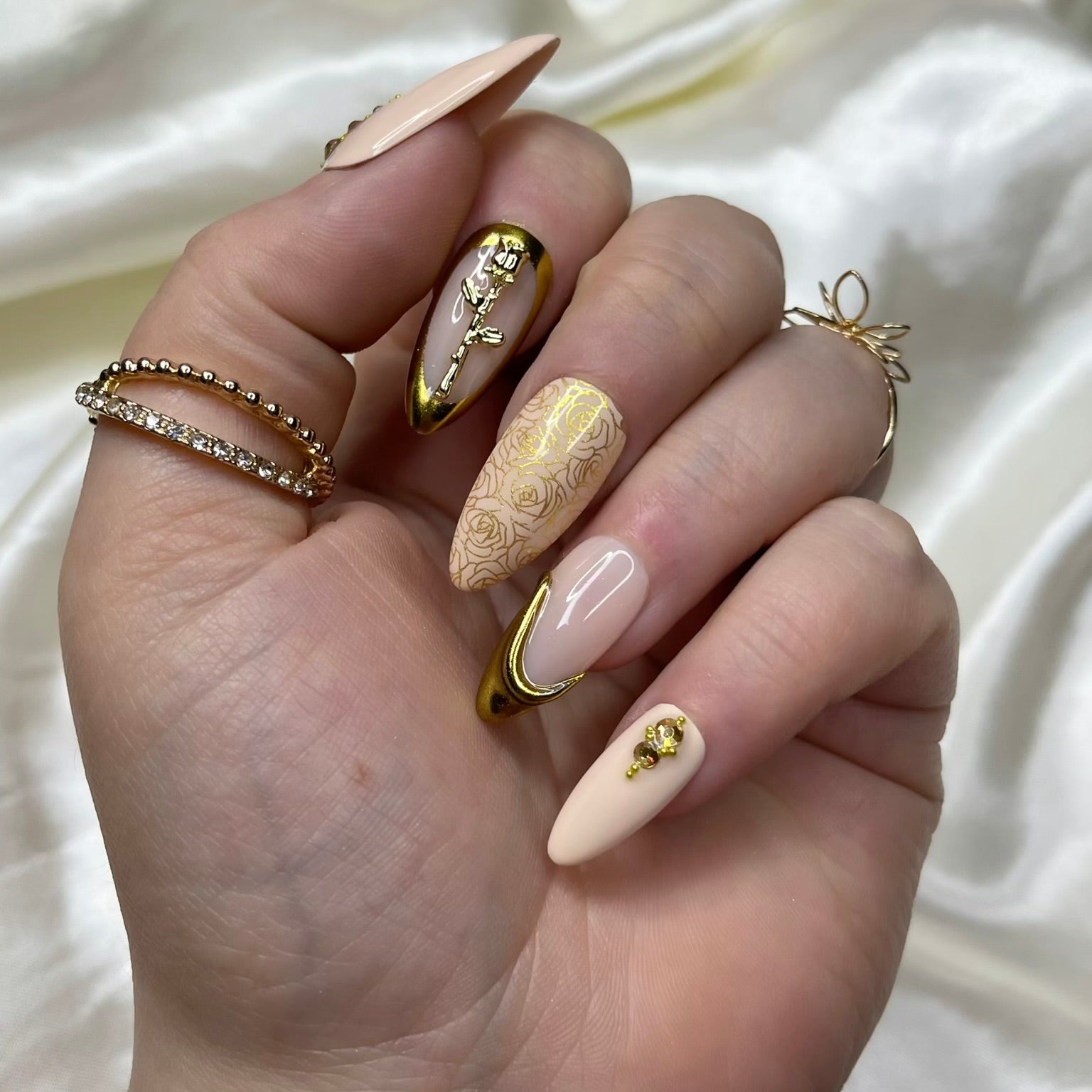 Gold rose charm nail art on nude luxury press-on nails with crystal details