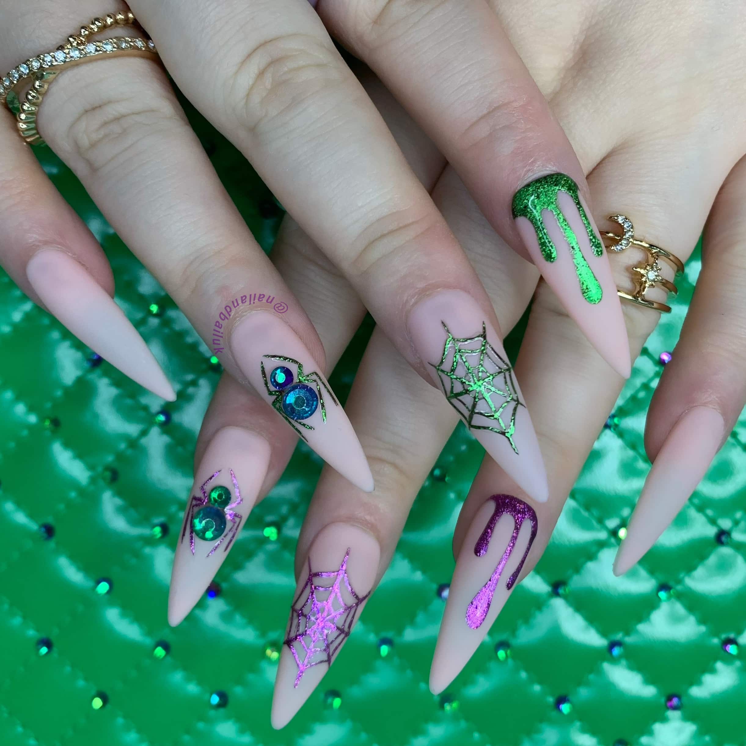 Halloween press-on nails with chrome drips, hand-painted spider webs, and crystal spider details