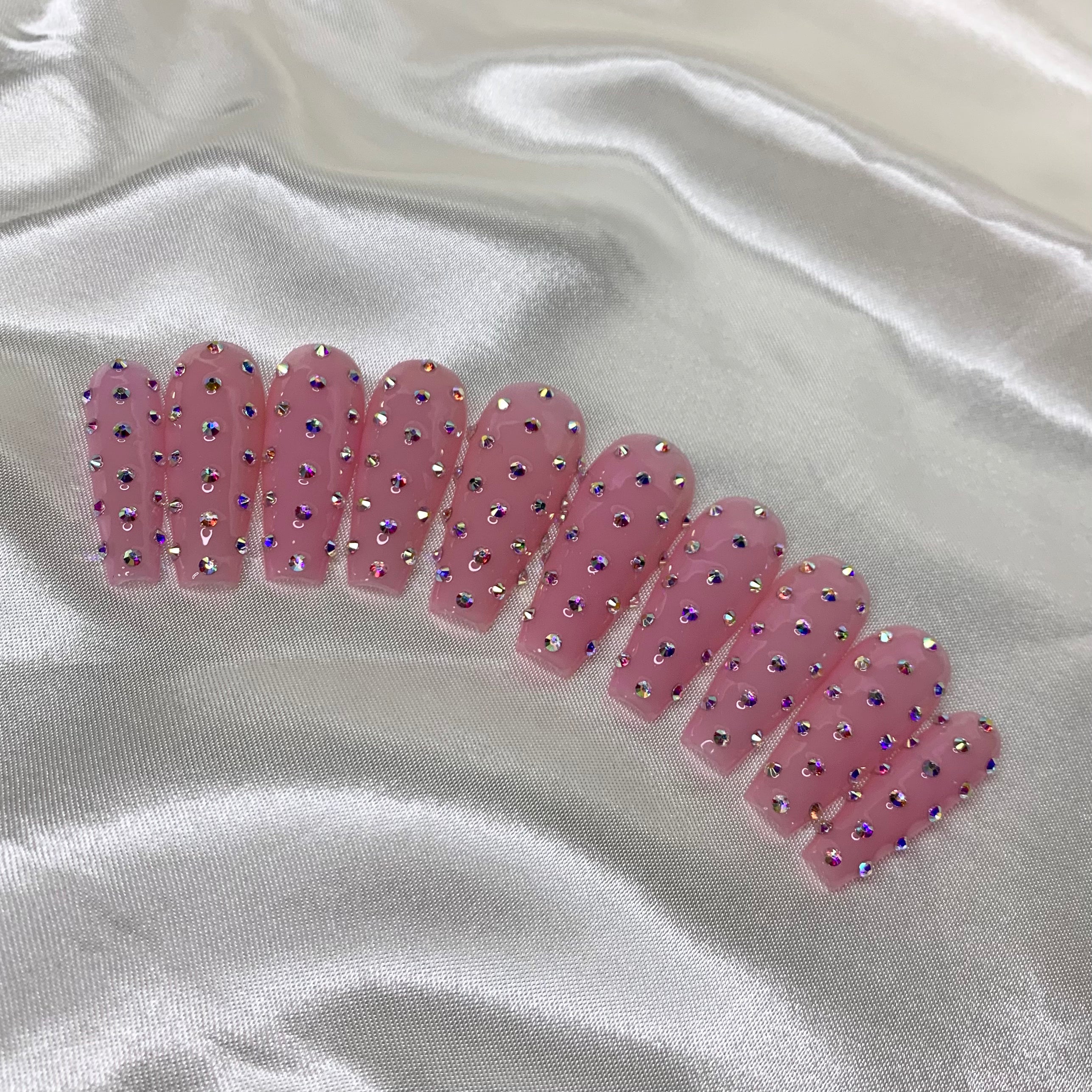 Pink nude press-on nails with silver AB crystal diamond patterns and luxury glam details