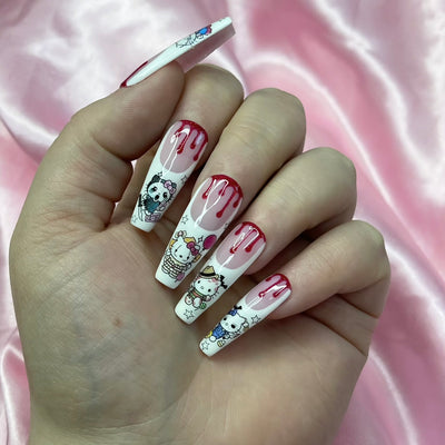 Horror Hello Kitty-inspired press-on nails with blood drip French tips and spooky nail art