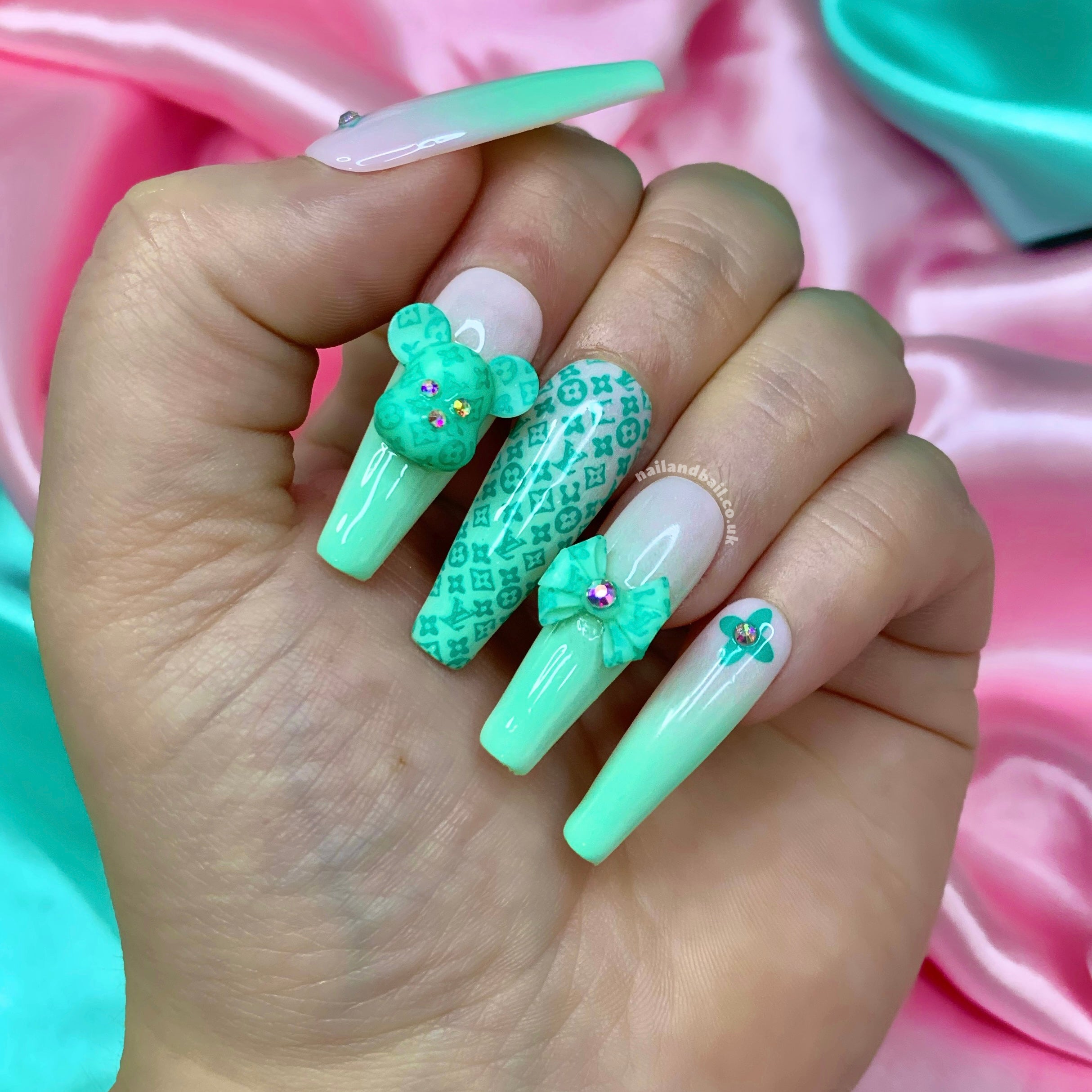 Mint ombré press-on nails with bear charms, bow nail art, and luxury-inspired details