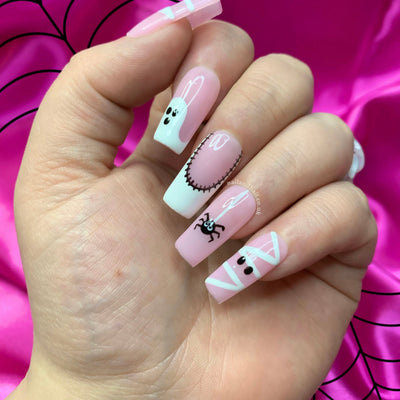 Halloween press-on nails with mummy nail art, ghost details, and patchwork French tips