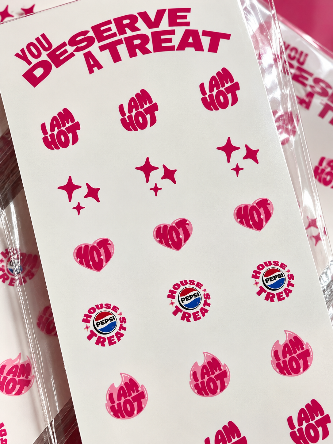 Close-up view of custom pink Pepsi nail decals featuring branded House Treats logos and I AM HOT designs