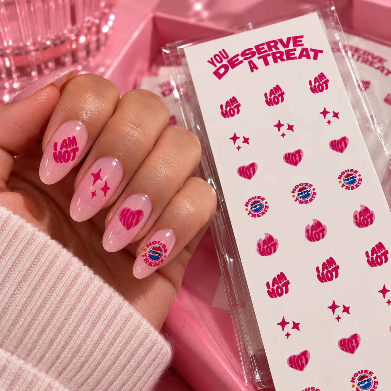 Pink nails decorated with custom Pepsi event nail decals alongside the matching decal sheet 