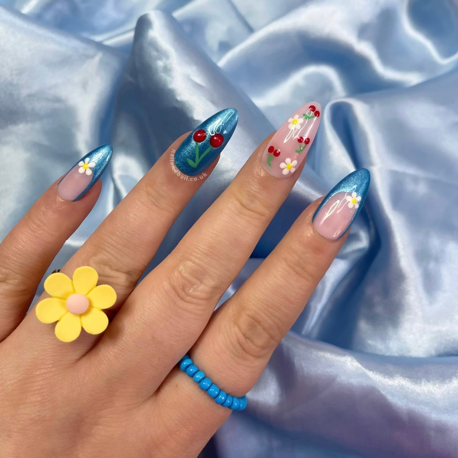 Introducing “Summer Days!” These handmade press-on nails feature bright blue shimmer tips, delicate daisies, and playful cherries. Easy to apply and perfect for a stylish summer look!