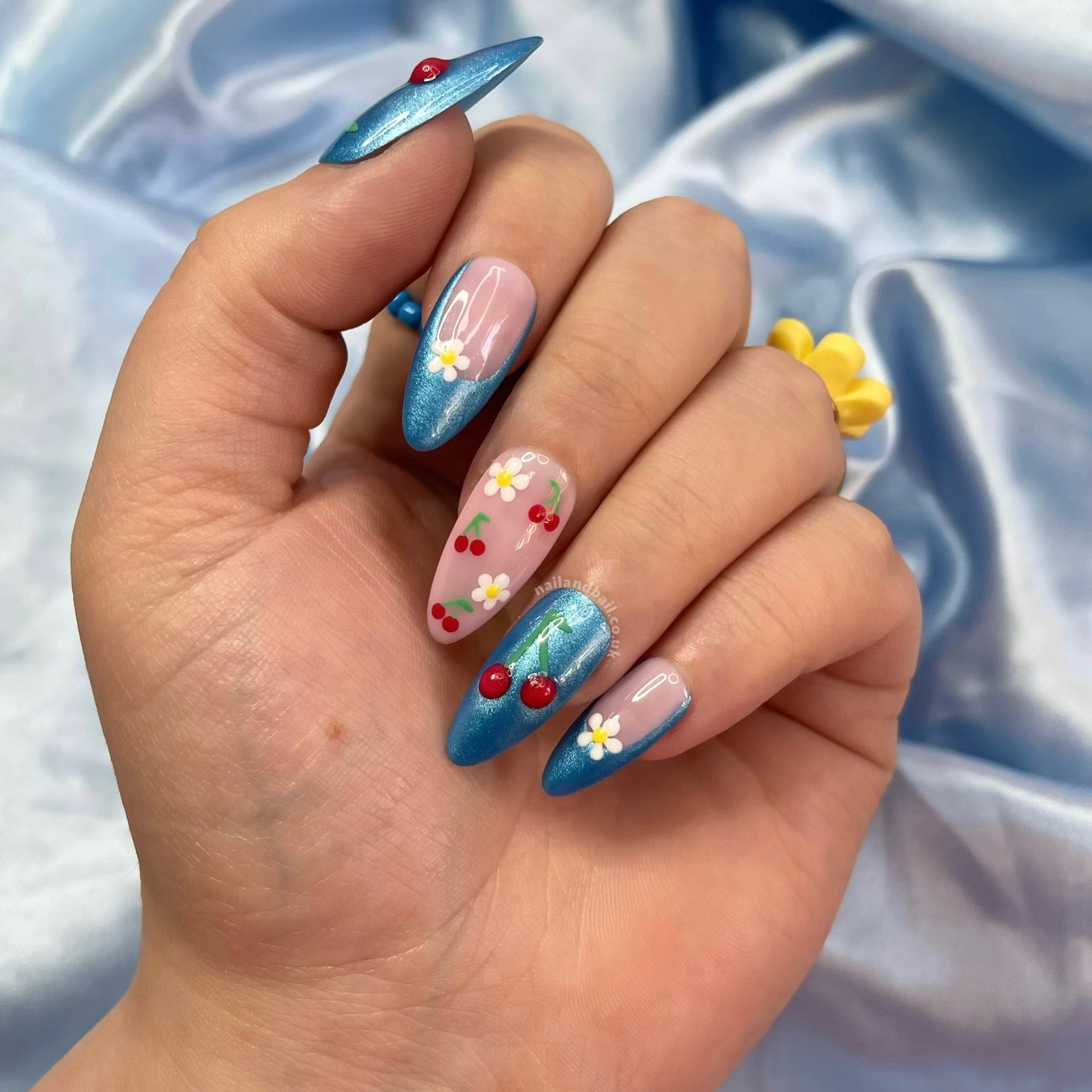 Introducing “Summer Days!” These handmade press-on nails feature bright blue shimmer tips, delicate daisies, and playful cherries. Easy to apply and perfect for a stylish summer look!