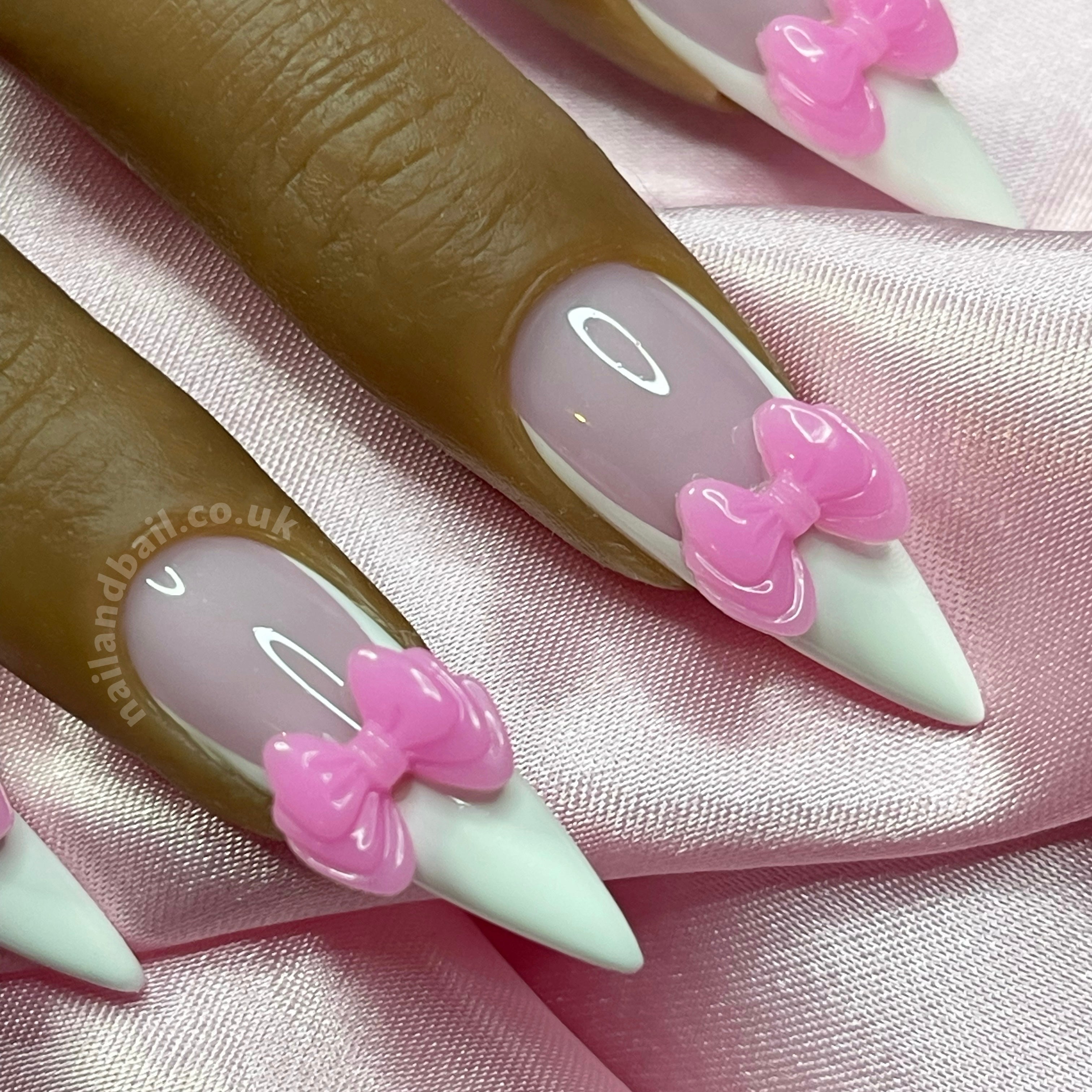 Handmade pink 3D bow nail art on elegant French tip press-on nails