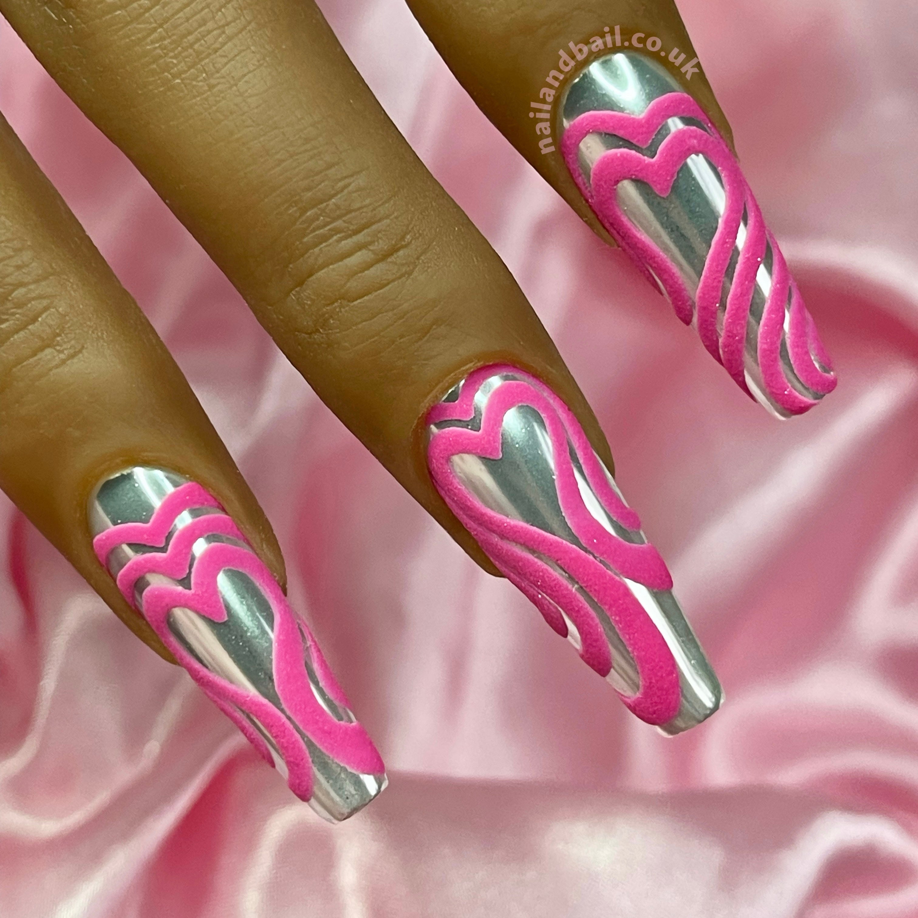 Bright pink overlapping heart nail art on silver chrome press-on nails