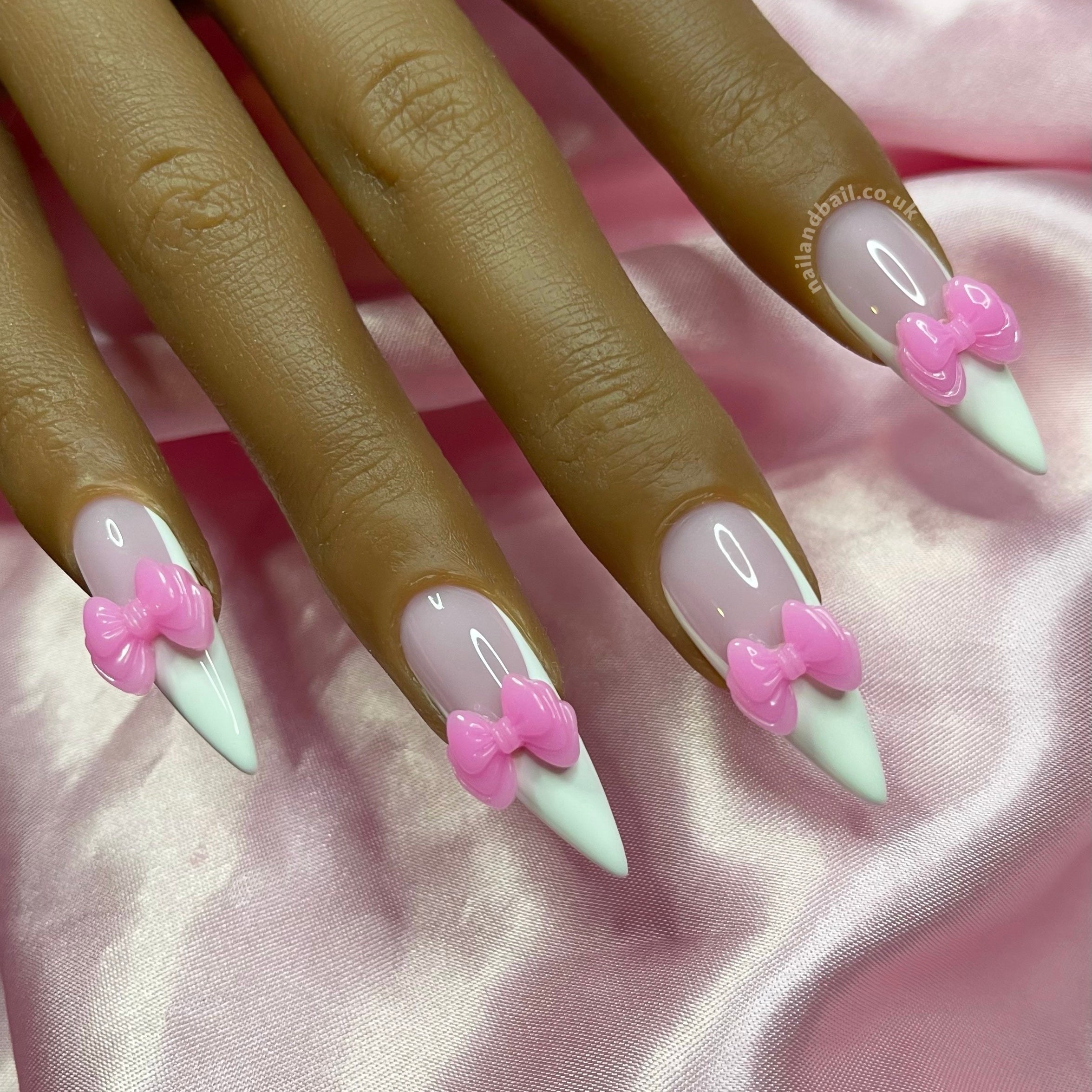 Pink and white French tip press-on nails with handmade 3D bow nail art