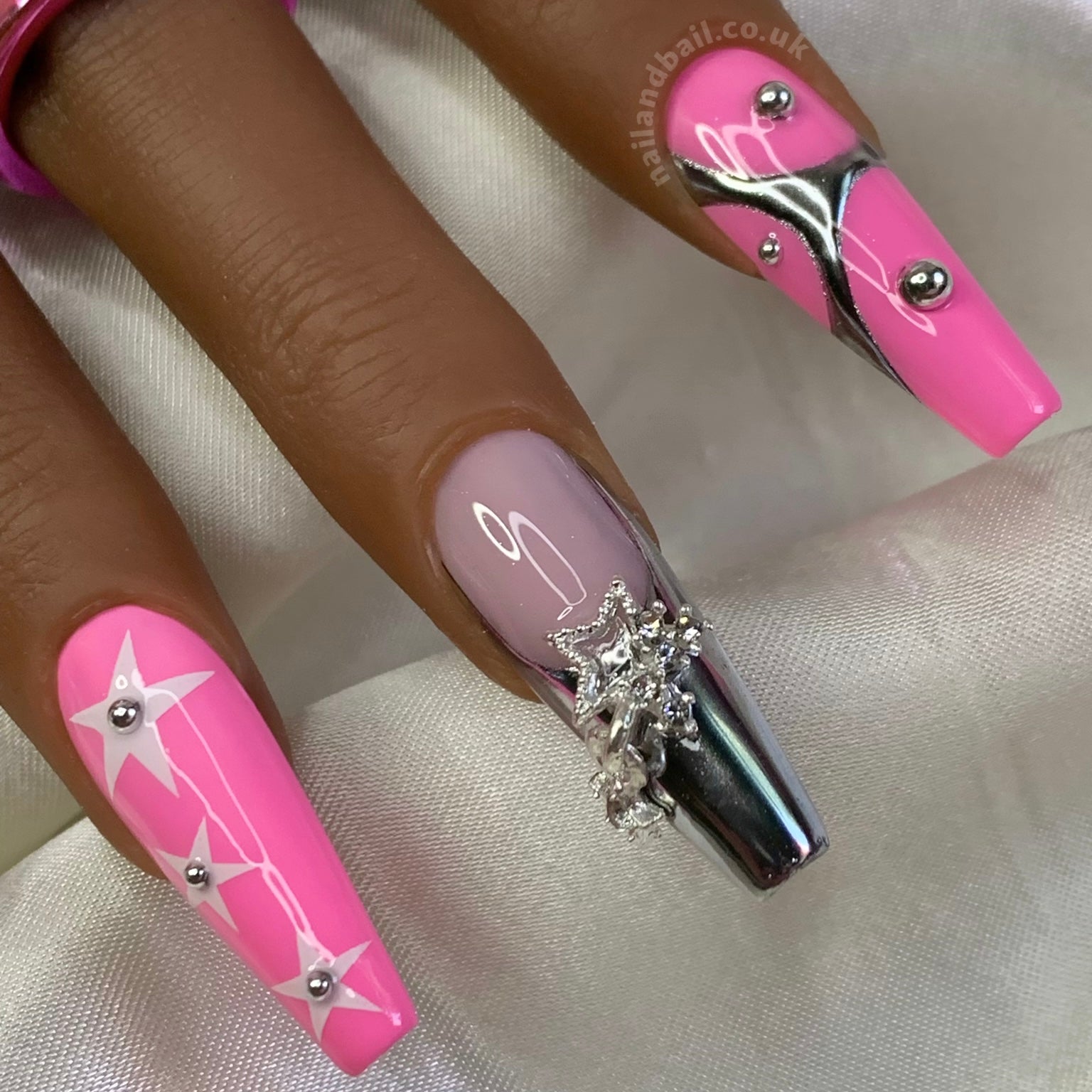 Star charm nail art on silver French tip press-on nails
