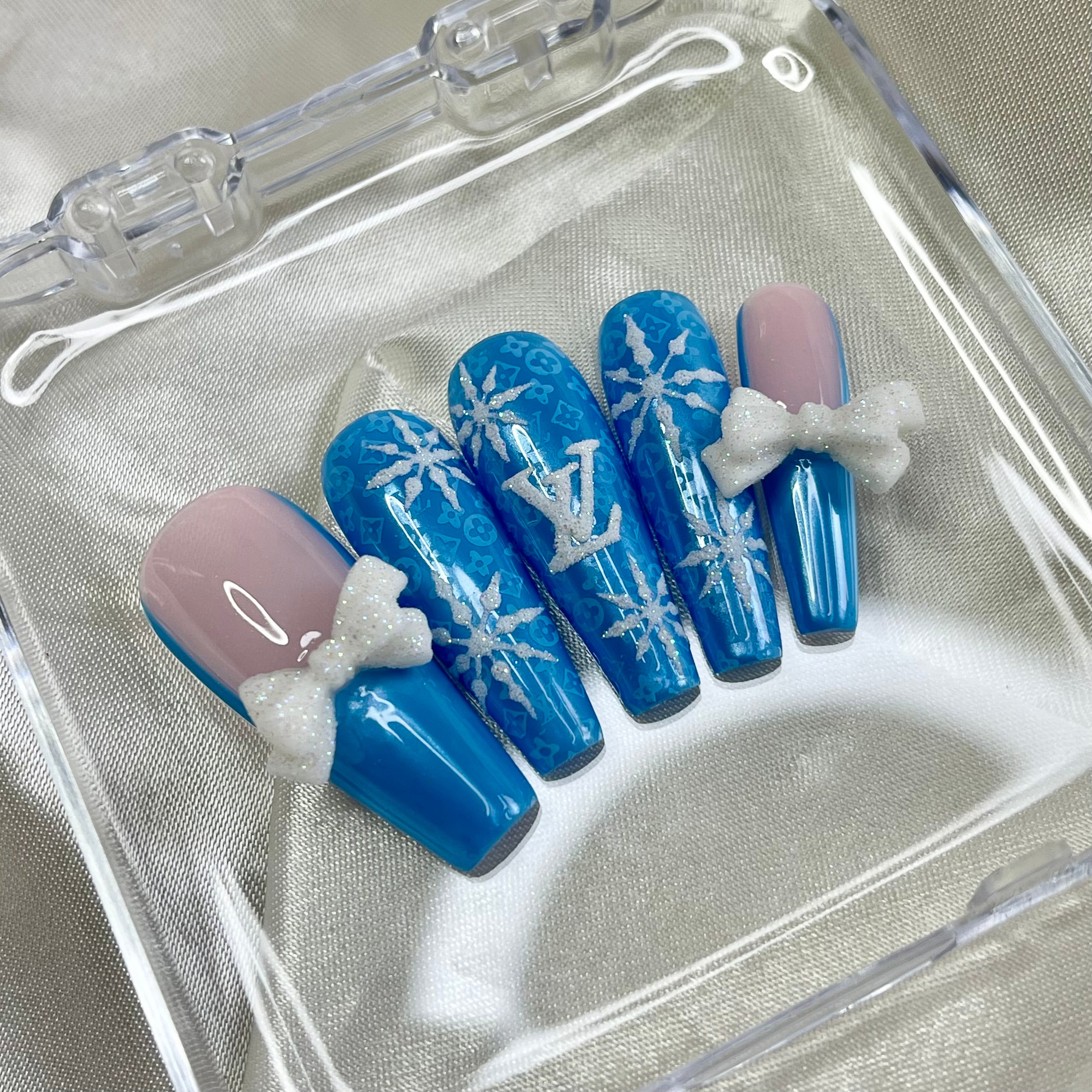 White snowflake nail art on blue chrome winter press-on nails