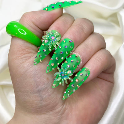Green Halloween press-on nails with spider nail art, crystals, and matte transparent bases