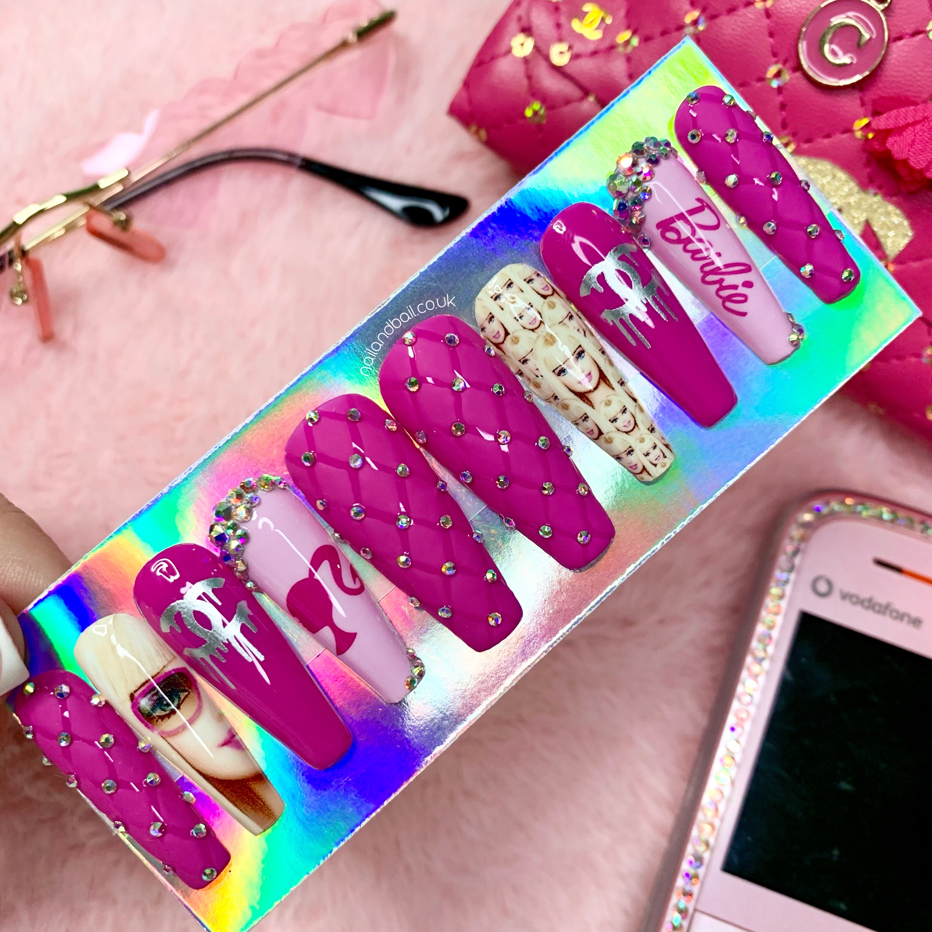 Dark pink Barbie-inspired press-on nails with quilted nail art, crystals, and luxury glam details