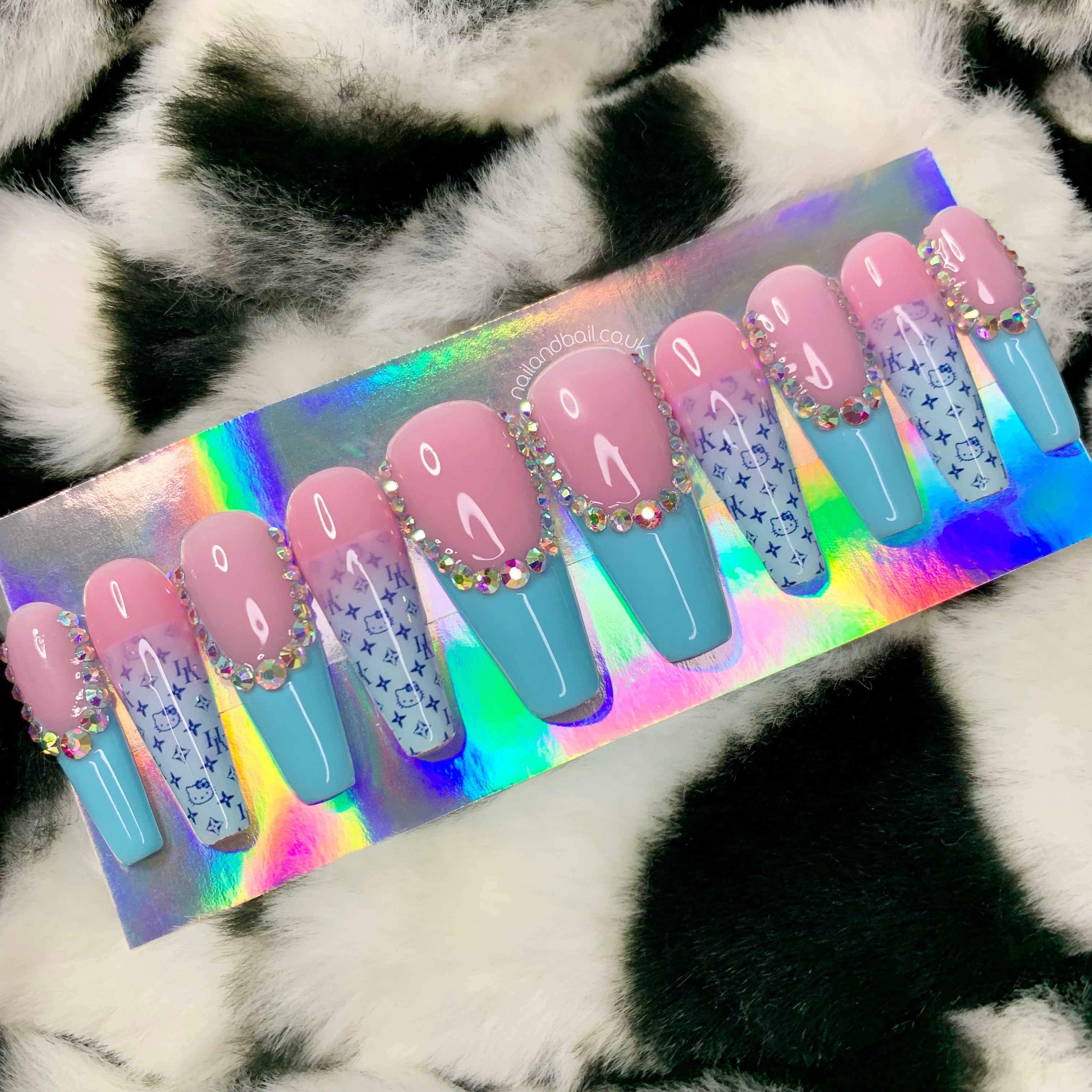 Blue kawaii glam press-on nails worn on hand with French tips and hello kitty nail art