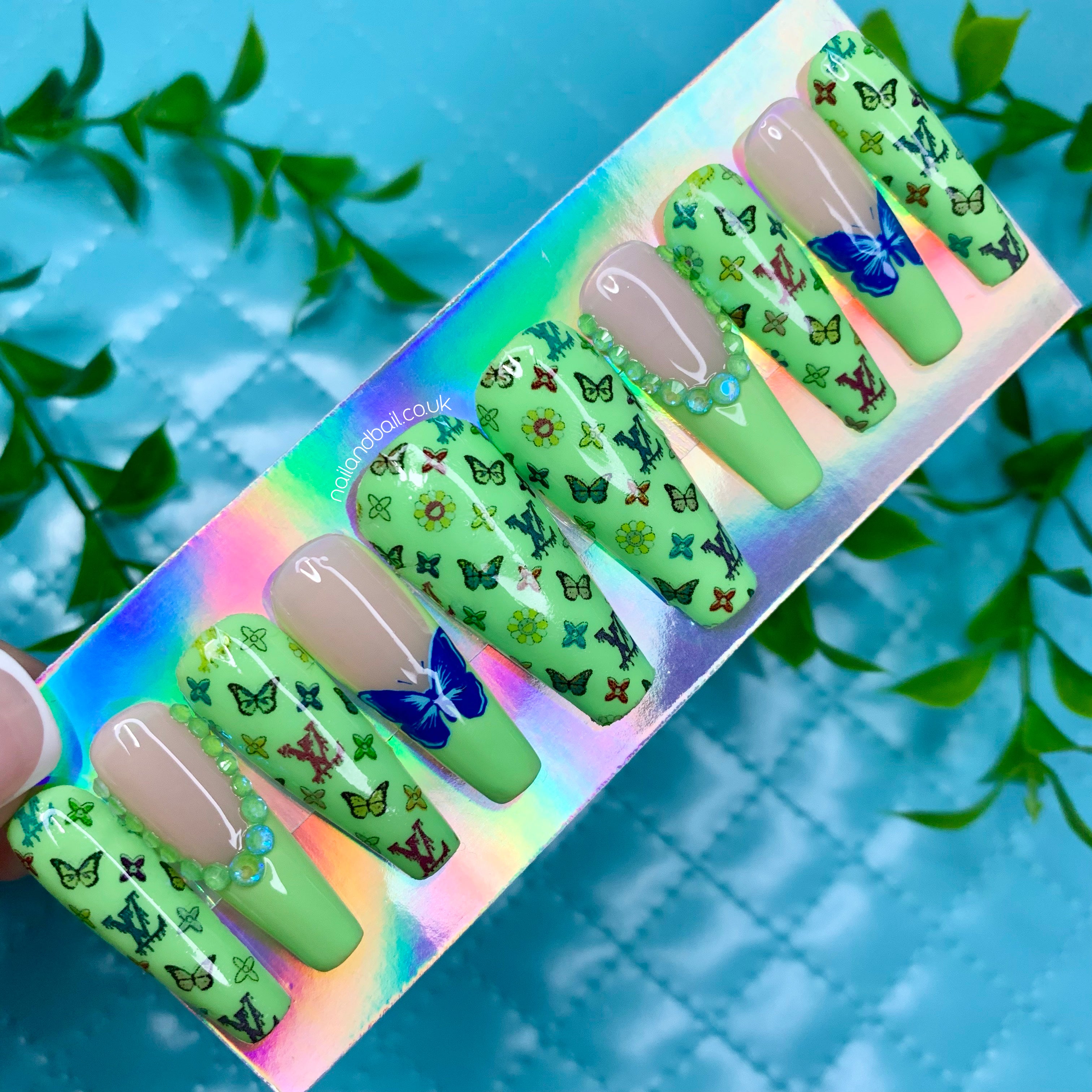 Colourful butterfly nail art on light green luxury-inspired press-on nails