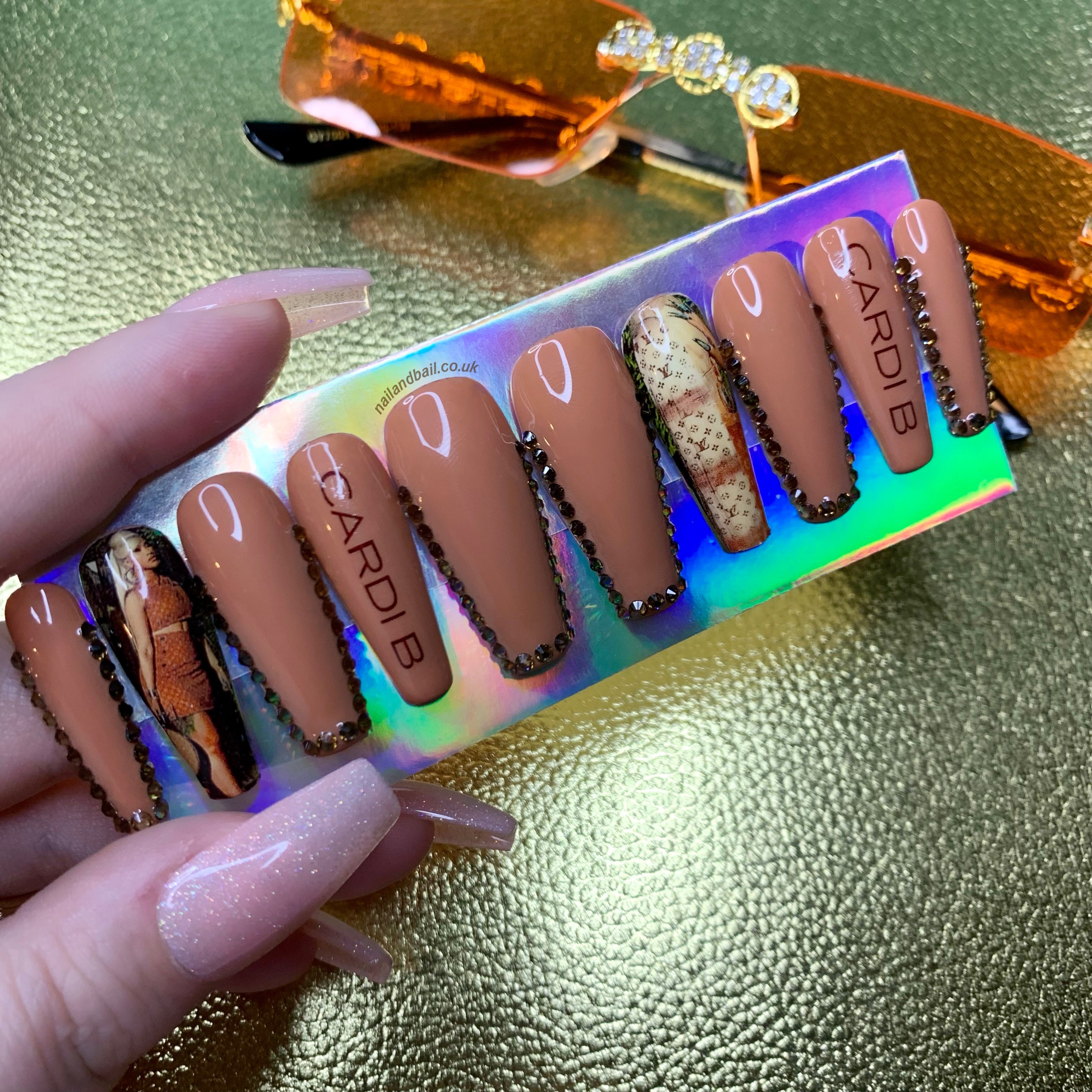 Brown press-on nails with Cardi B-inspired artwork and sparkling brown crystal details