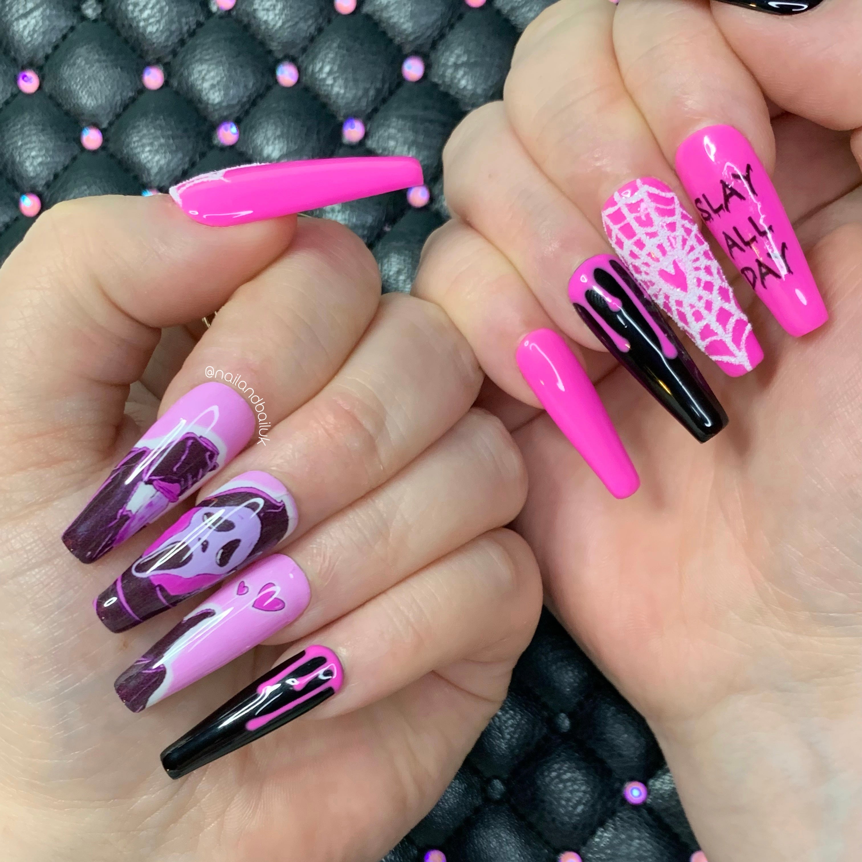 Pink and black horror press-on nails with slasher-inspired nail art, spiderwebs, hearts, and pink drips