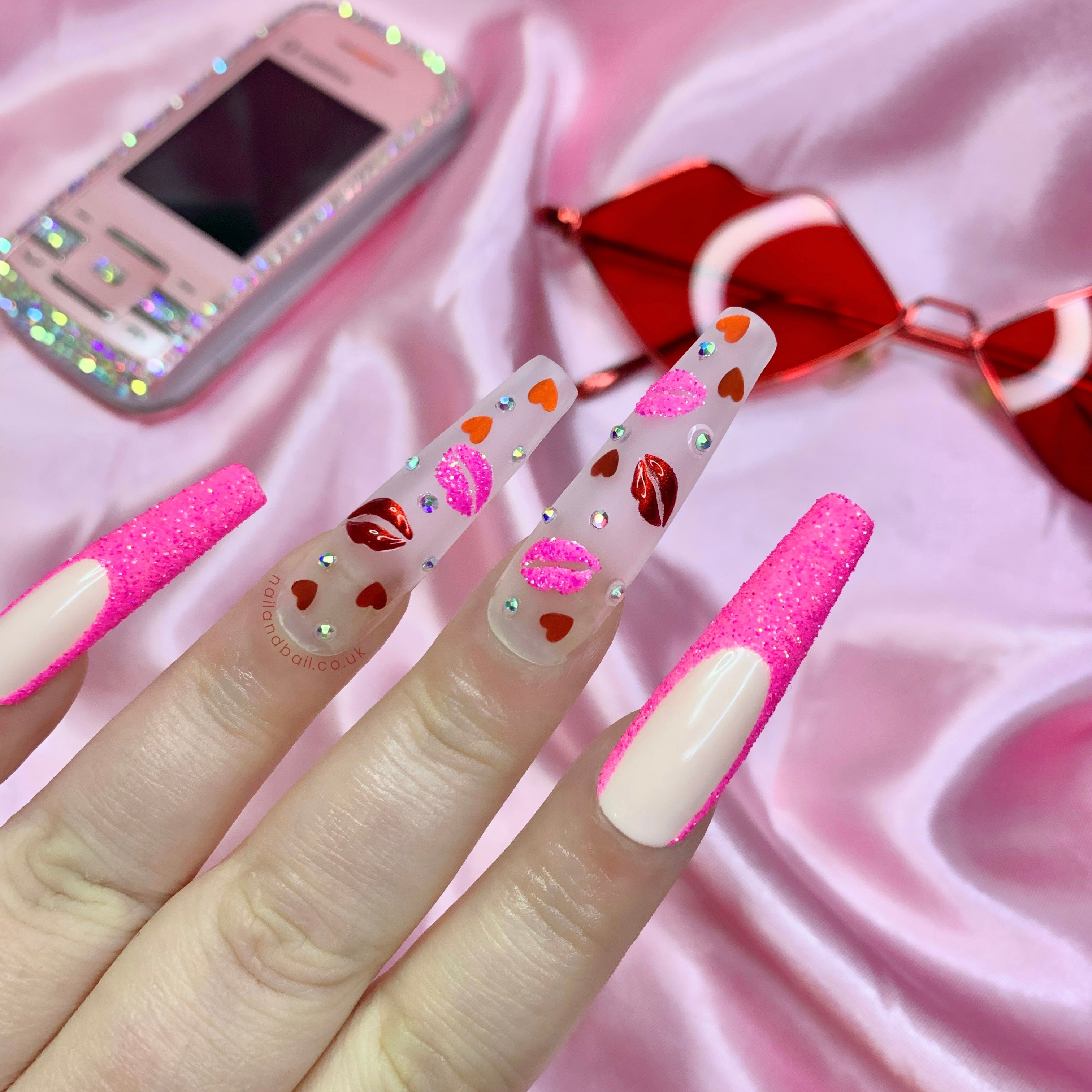 Red chrome lip nail art on romantic pink glitter press-on nails