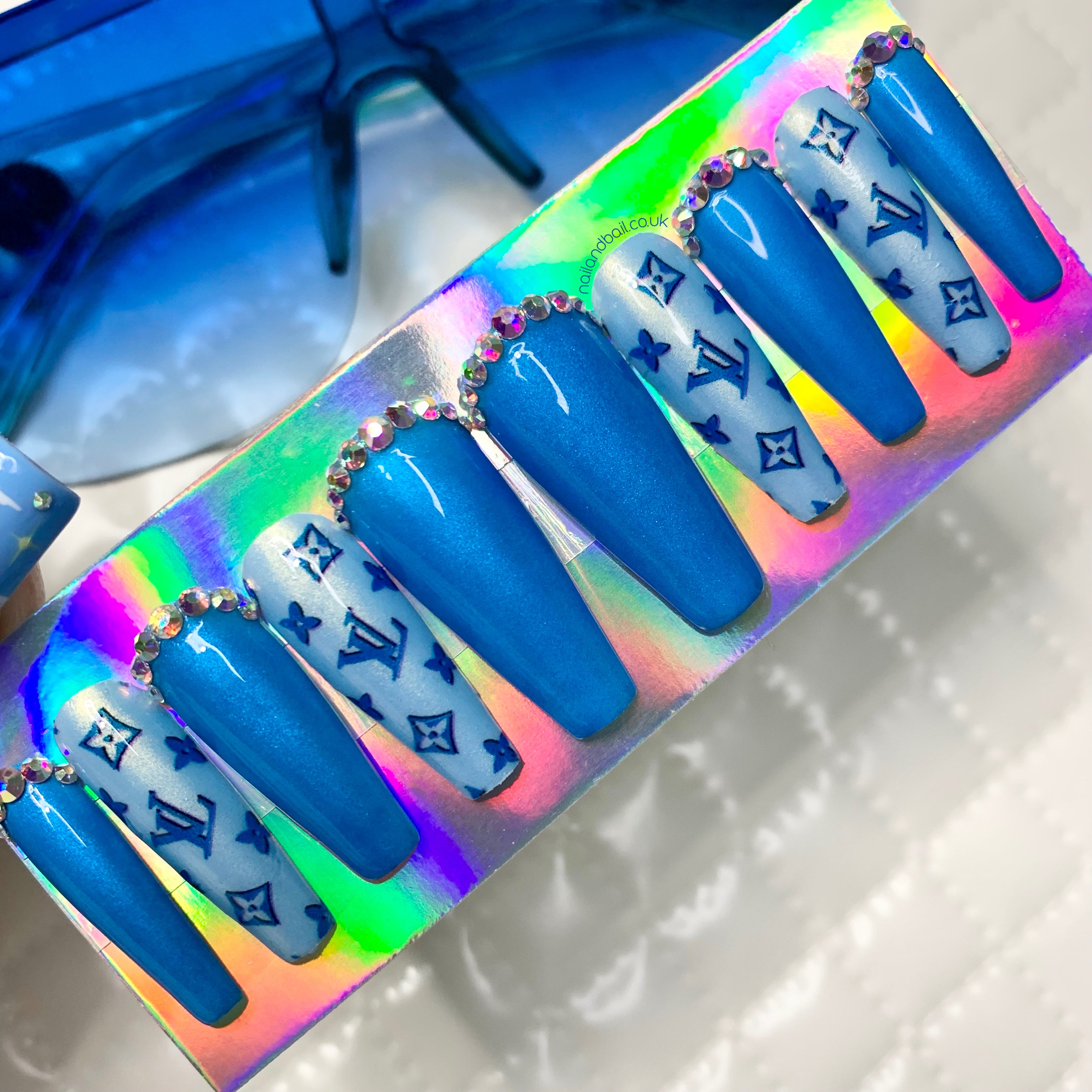 Crystal-lined cuticle details on dark blue shimmer press-on nails