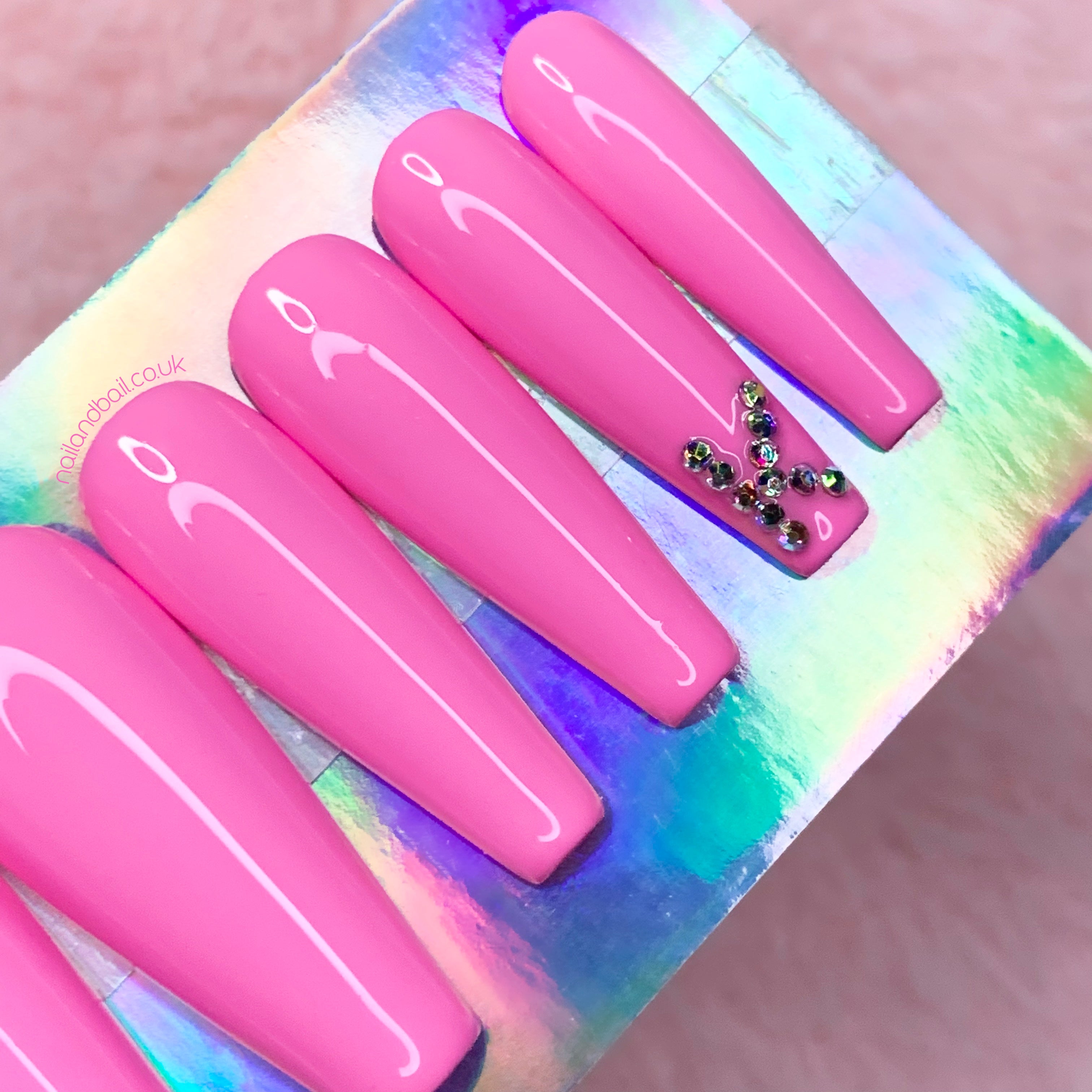 Custom crystal initial nail art on soft pink personalised press-on nails