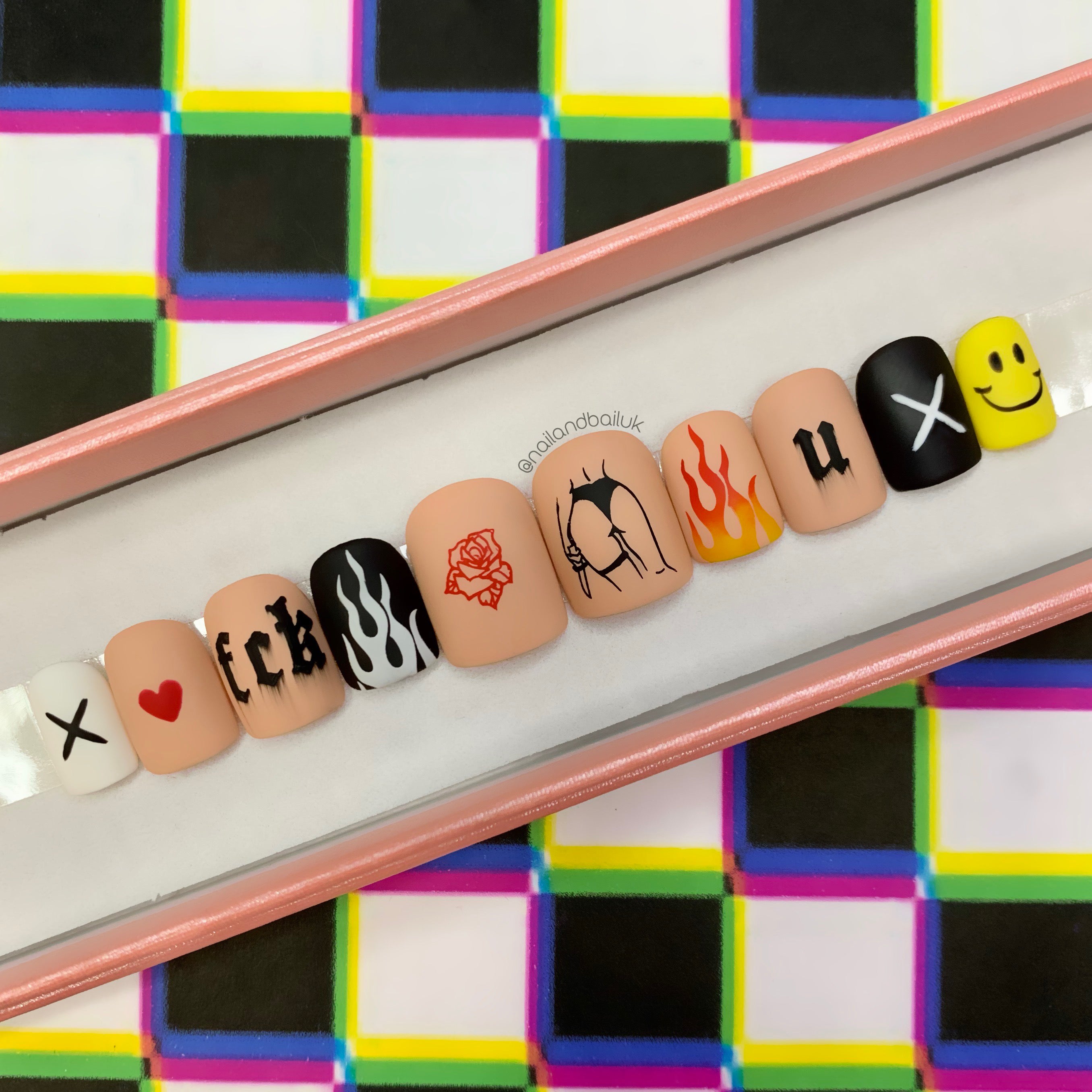 Statement flame press-on nails inspired by punk fashion and streetwear style