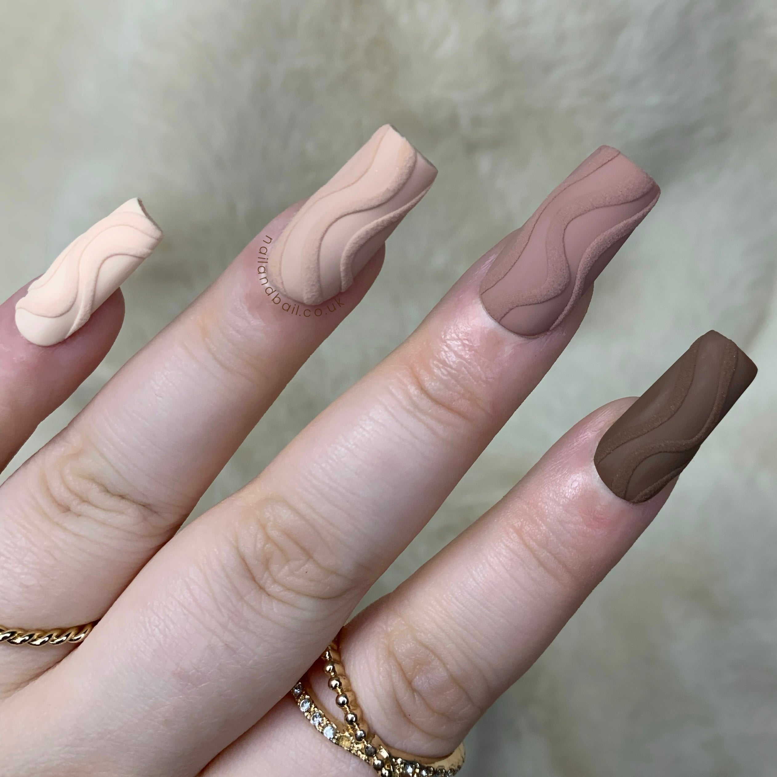 Raised swirl nail art on classy nude press-on nails