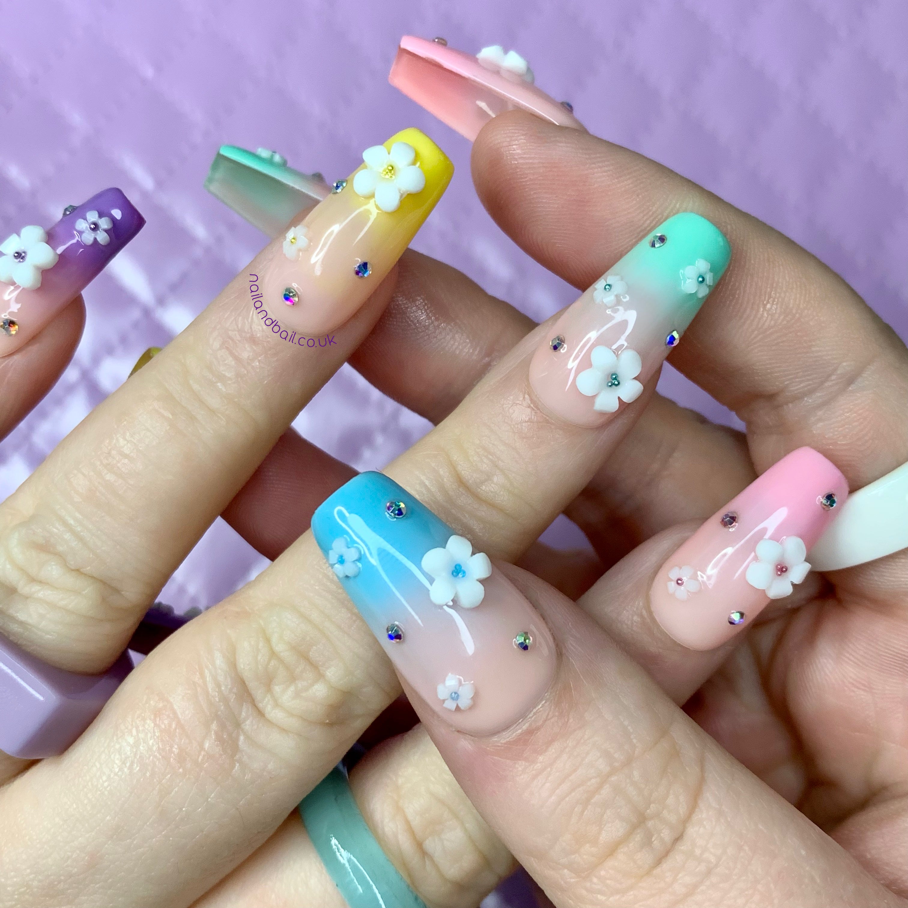 Pastel ombré press-on nails with floral charms, AB crystals, and colourful spring-inspired glam details