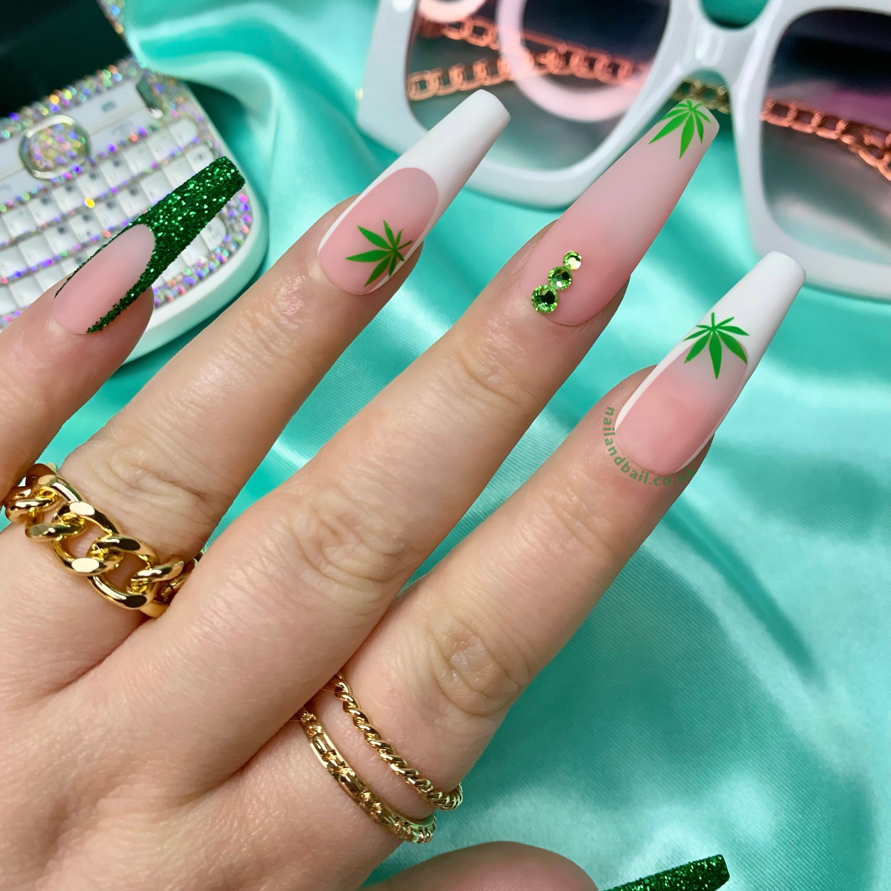 Green leaf-inspired nail art on matte nude and white press-on nails