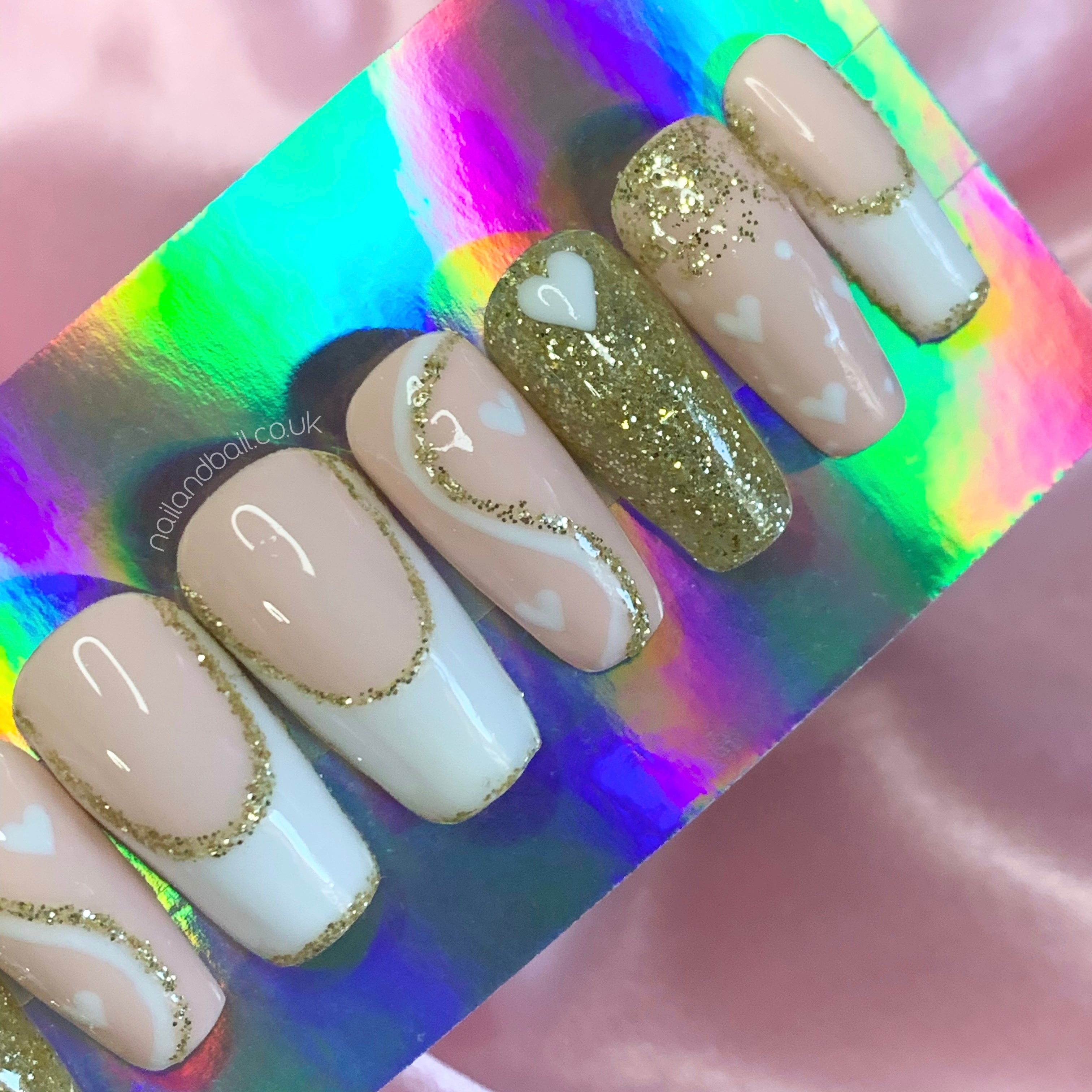 White and gold glitter yin yang heart nail art on nude press-on nails
