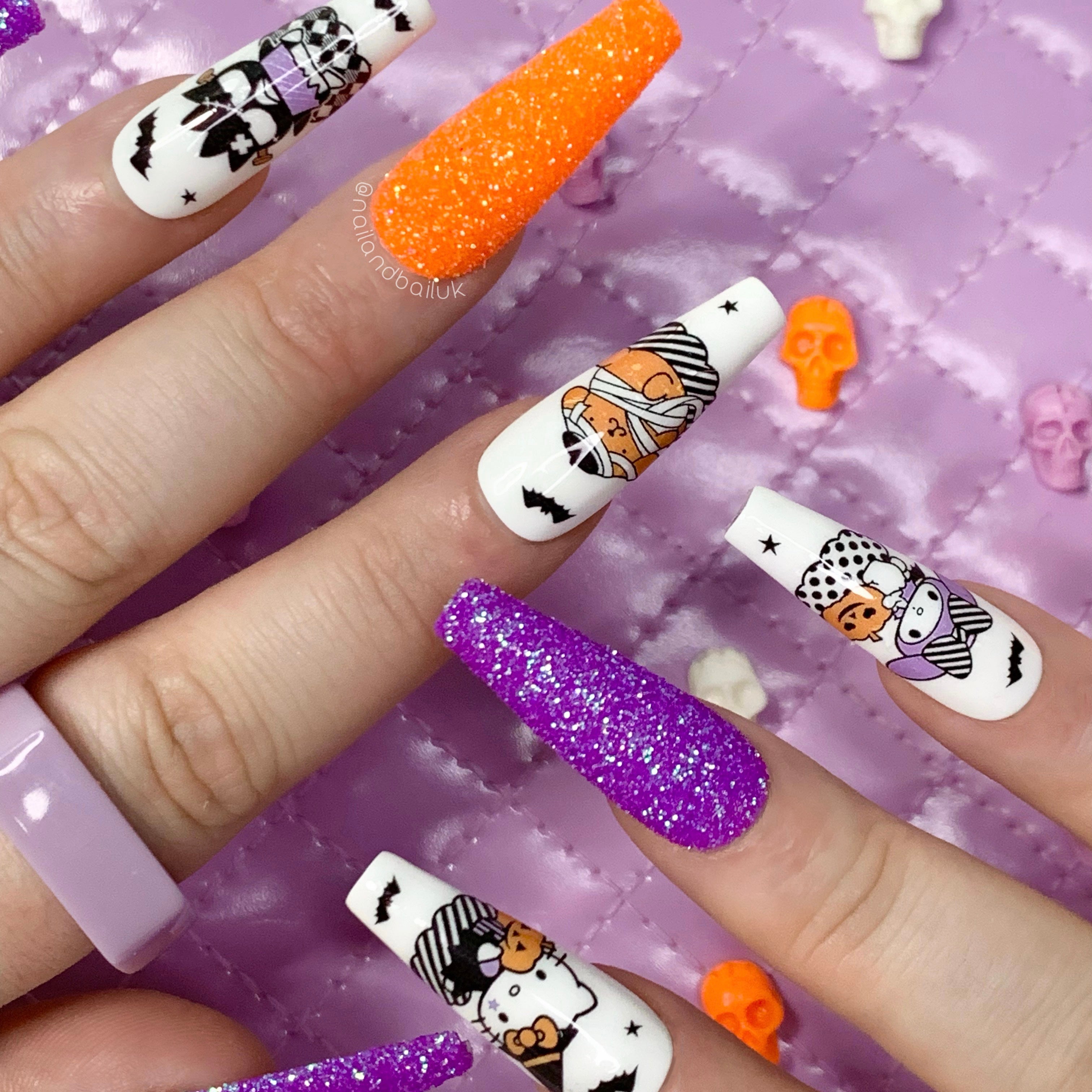 Kawaii Halloween press-on nails with glitter sugar textures, spooky character nail art, bats, stars, and pumpkins