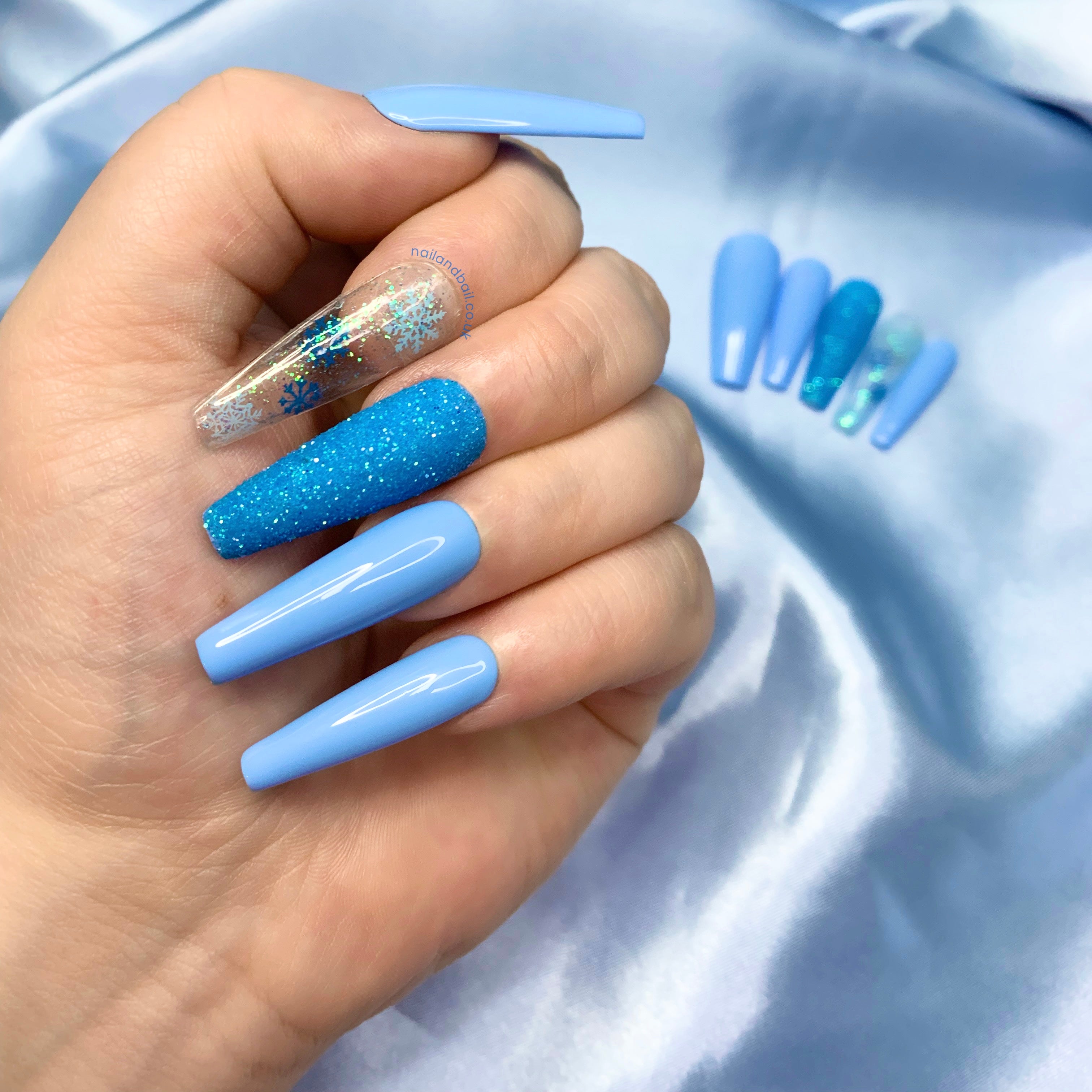 Iridescent glitter topper on icy blue winter press-on nails