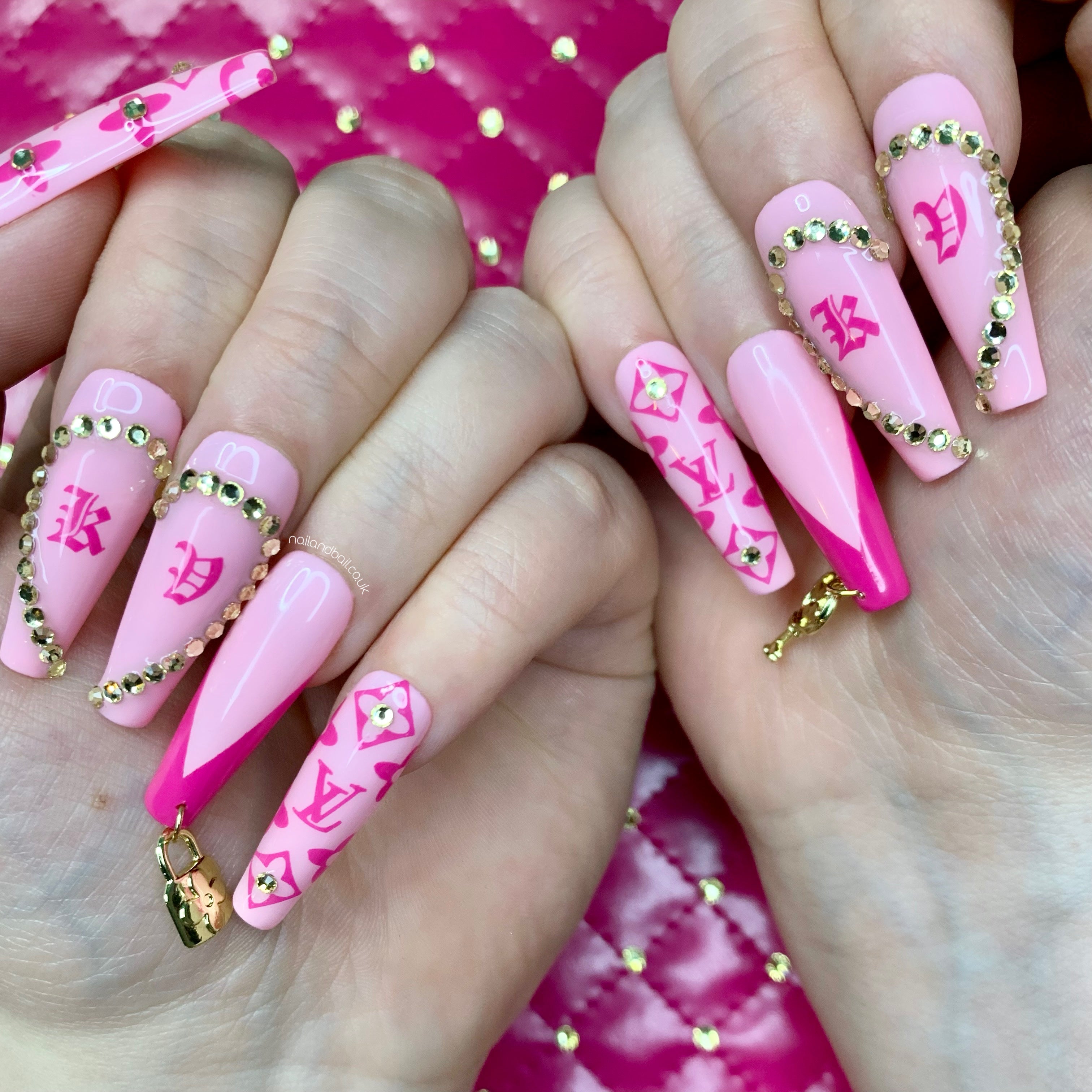 Pink Louis Vuitton heart initial press on nailsPersonalised pink press-on nails with crystal heart initials, luxury-inspired nail art, and gold locket charms