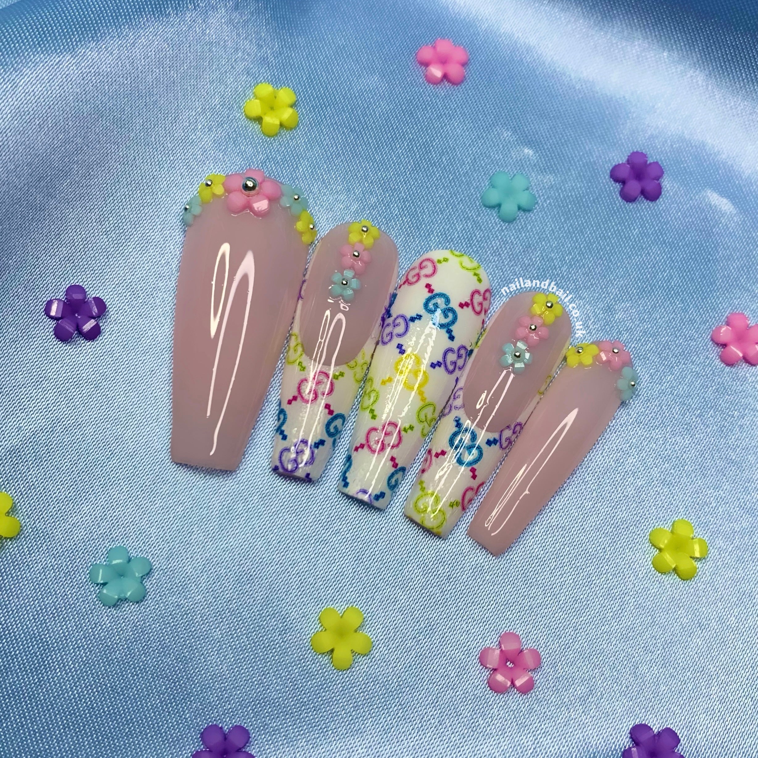 Multicolour designer-inspired nail art on glossy glam press-on nails