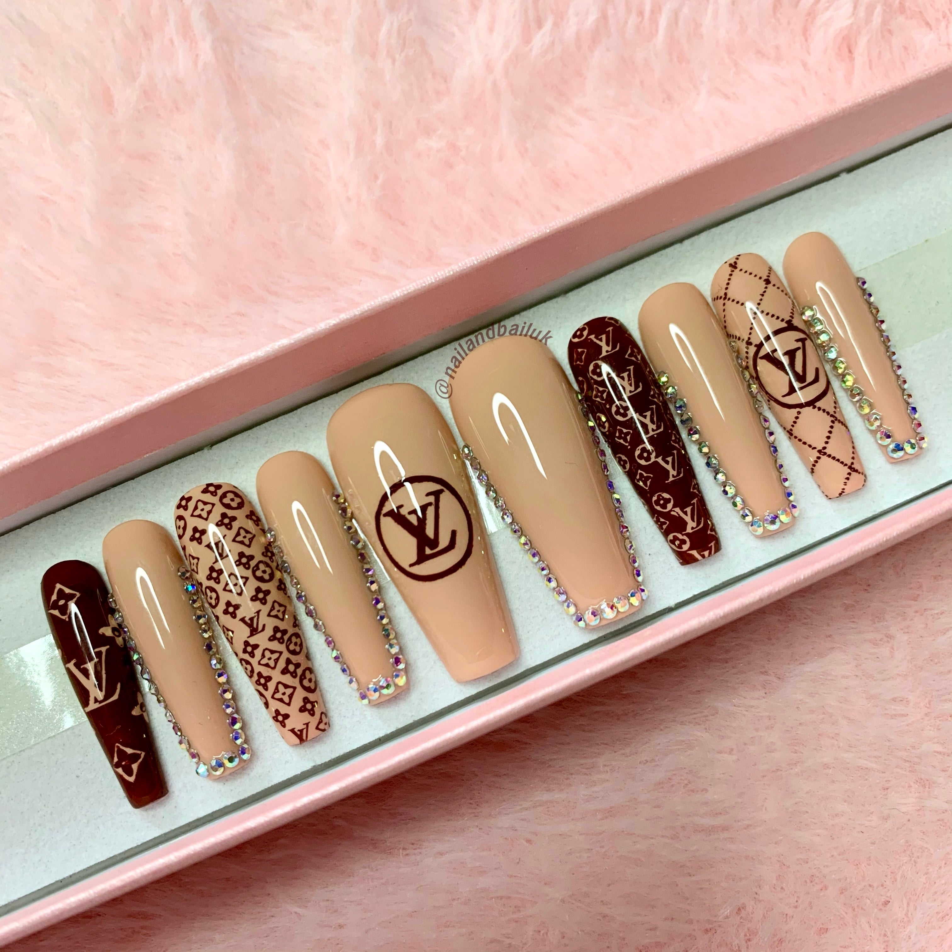 Nude press-on nails with dark brown luxury-inspired prints and silver AB crystal details