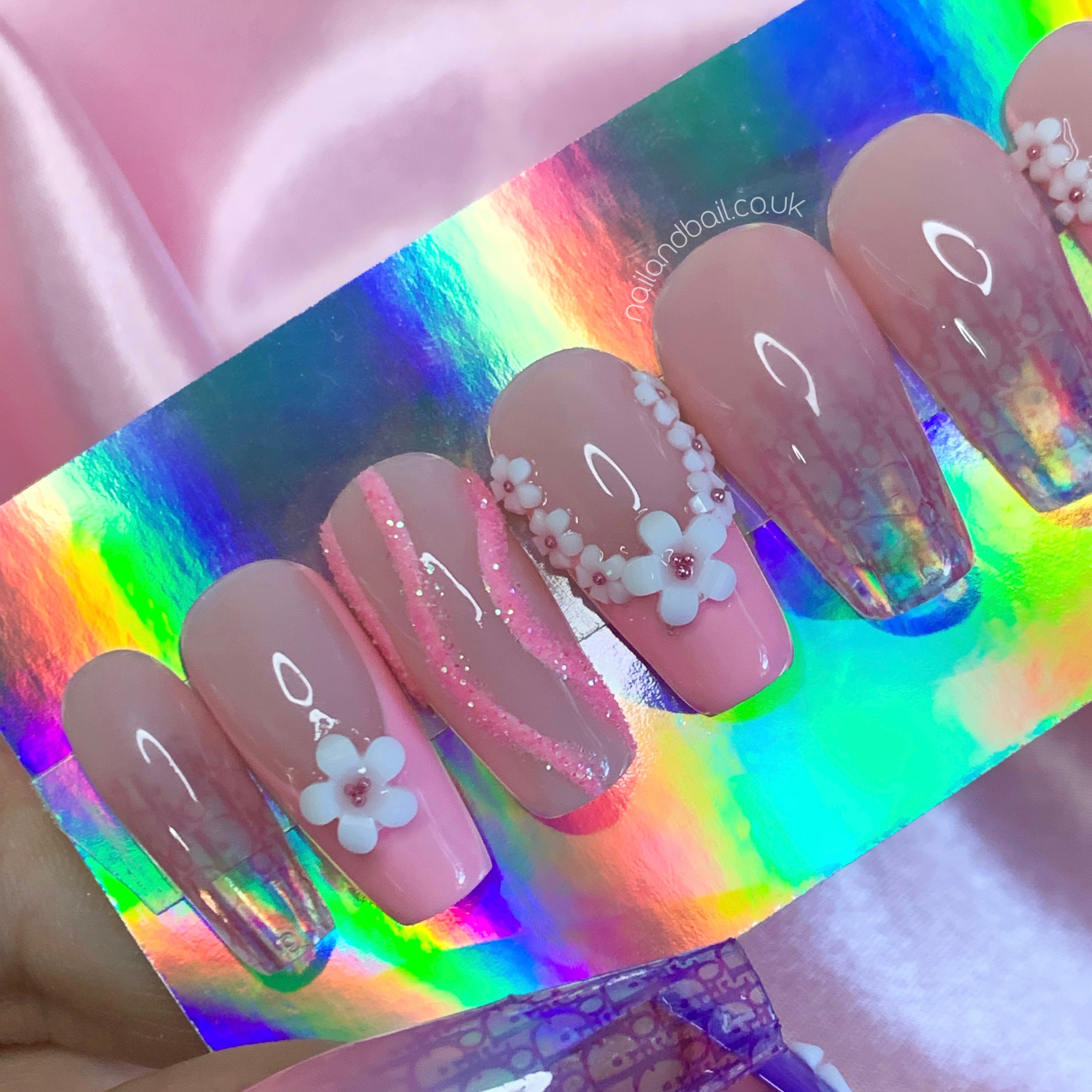 Nude ombré press-on nails with translucent tips and soft pink luxury-inspired details