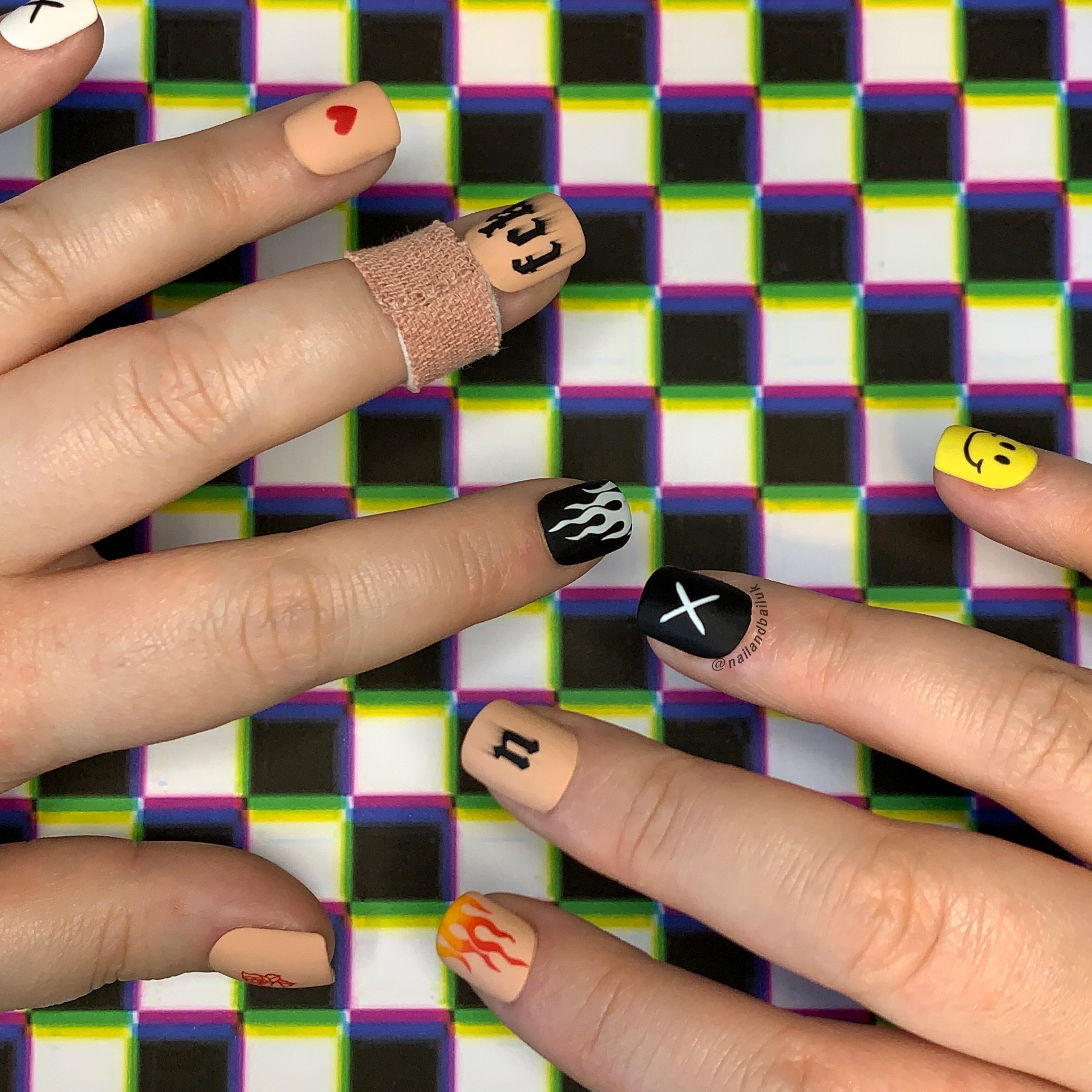 Punk-inspired press-on nails with bold flame nail art and edgy statement design