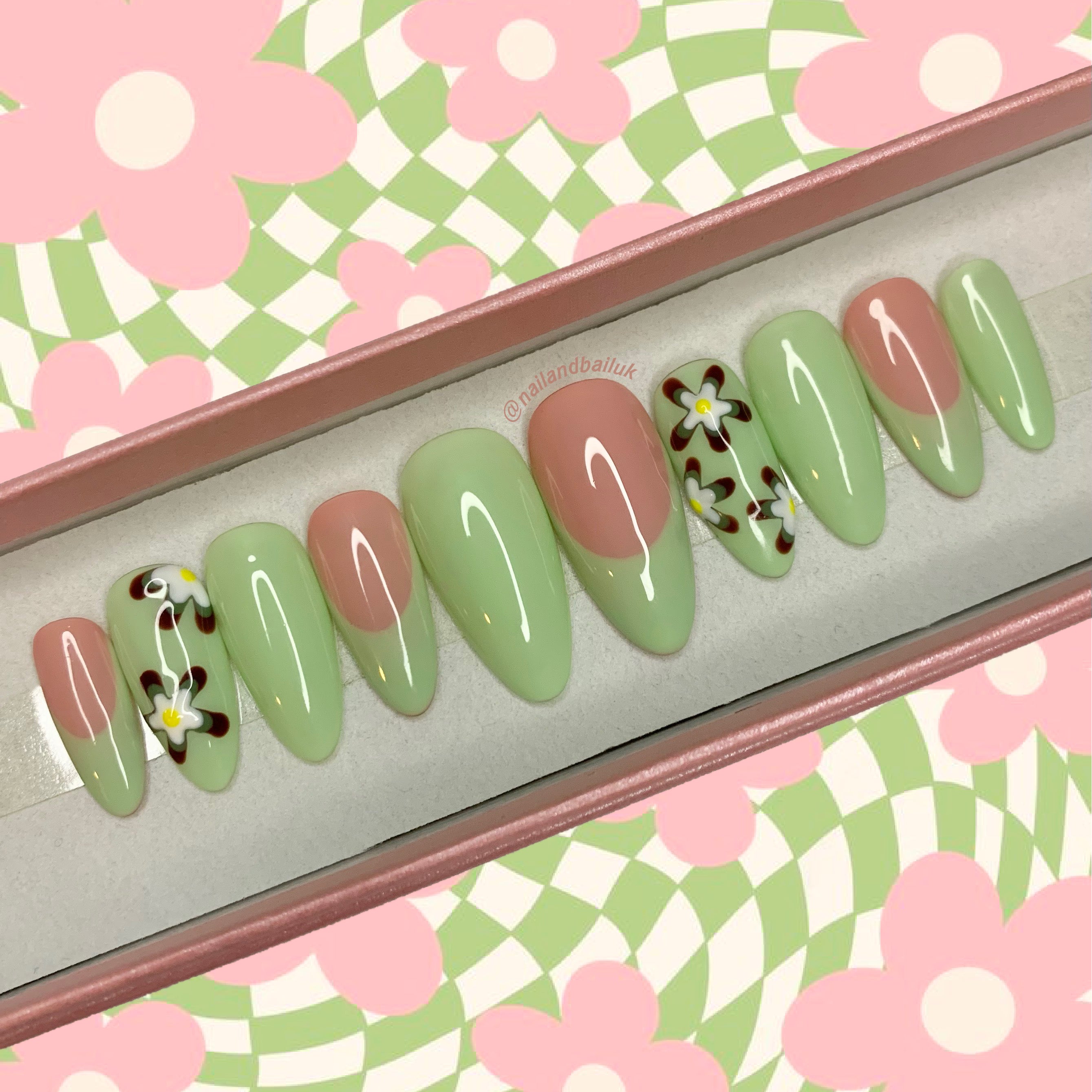 Green French tip press-on nails with brown, green, and white retro floral designs