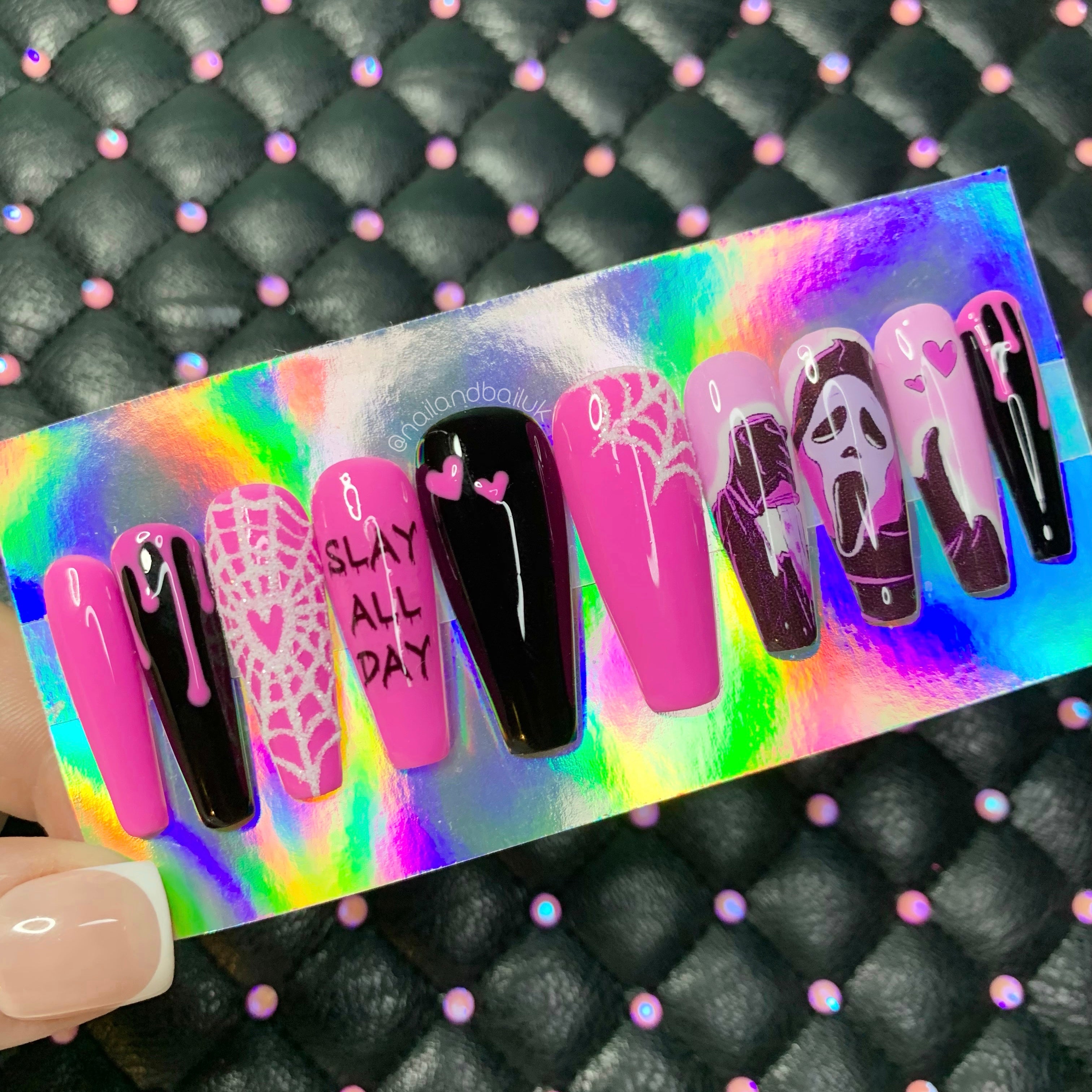 Slasher-inspired nail art with pink hearts on spooky horror press-on nails
